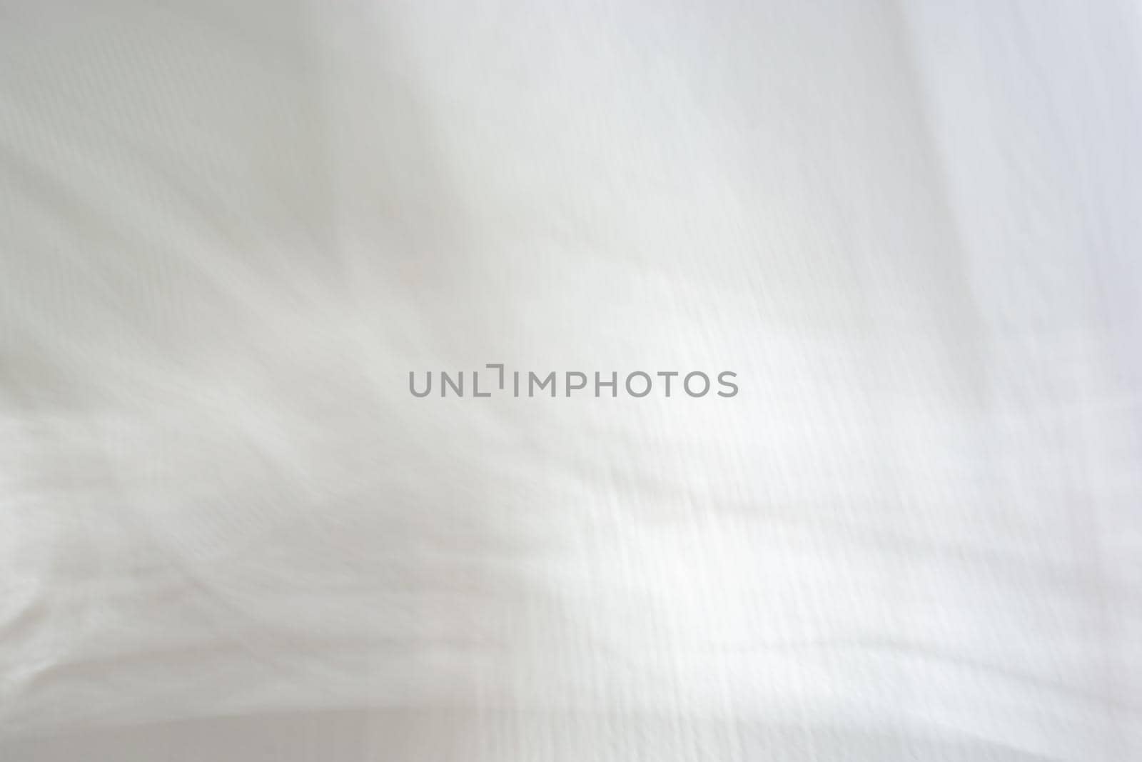 Abstract background, soft blurred shadows from a window on a white concrete wall.