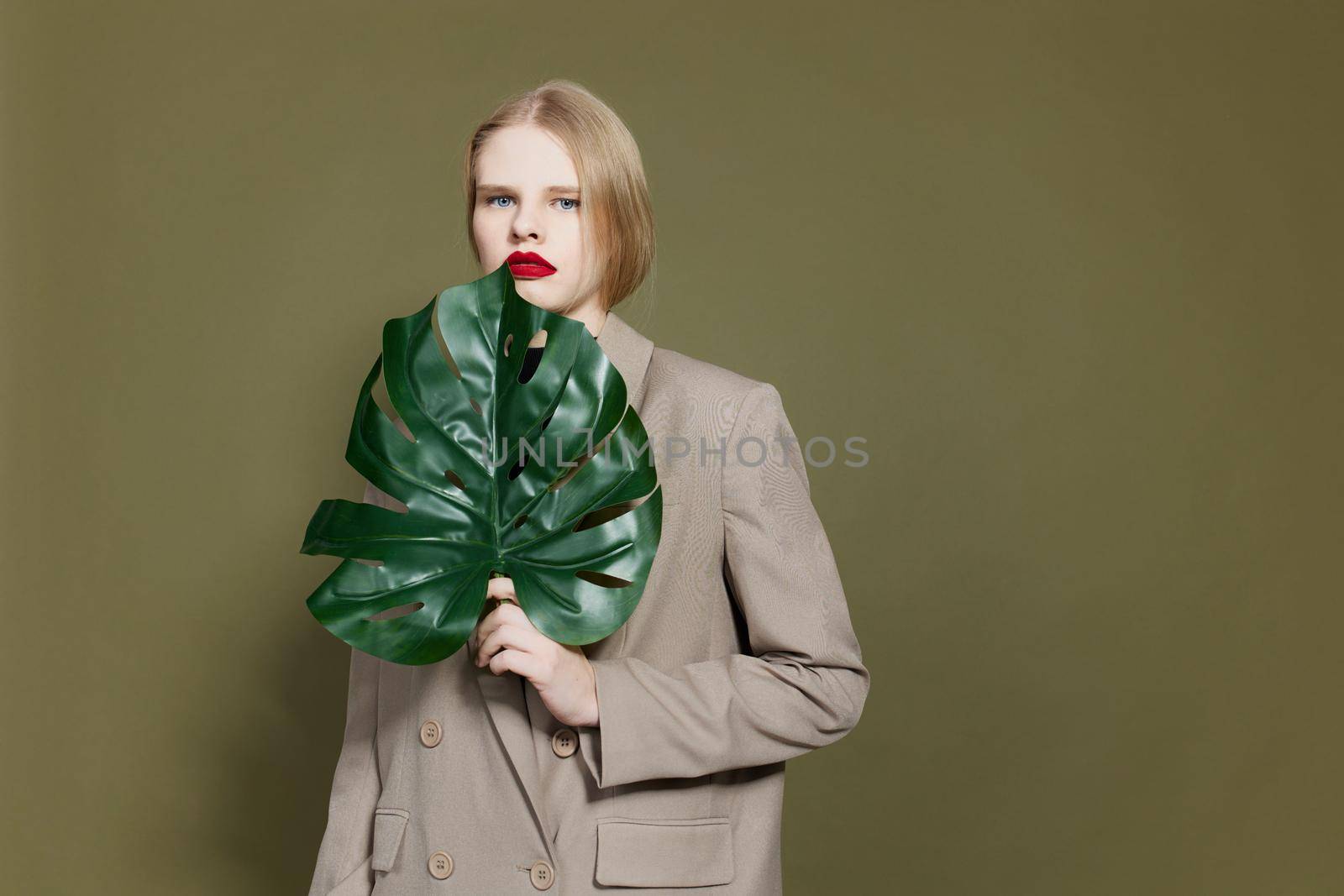 fashionable woman red lips palm leaf charm fashion isolated background. High quality photo