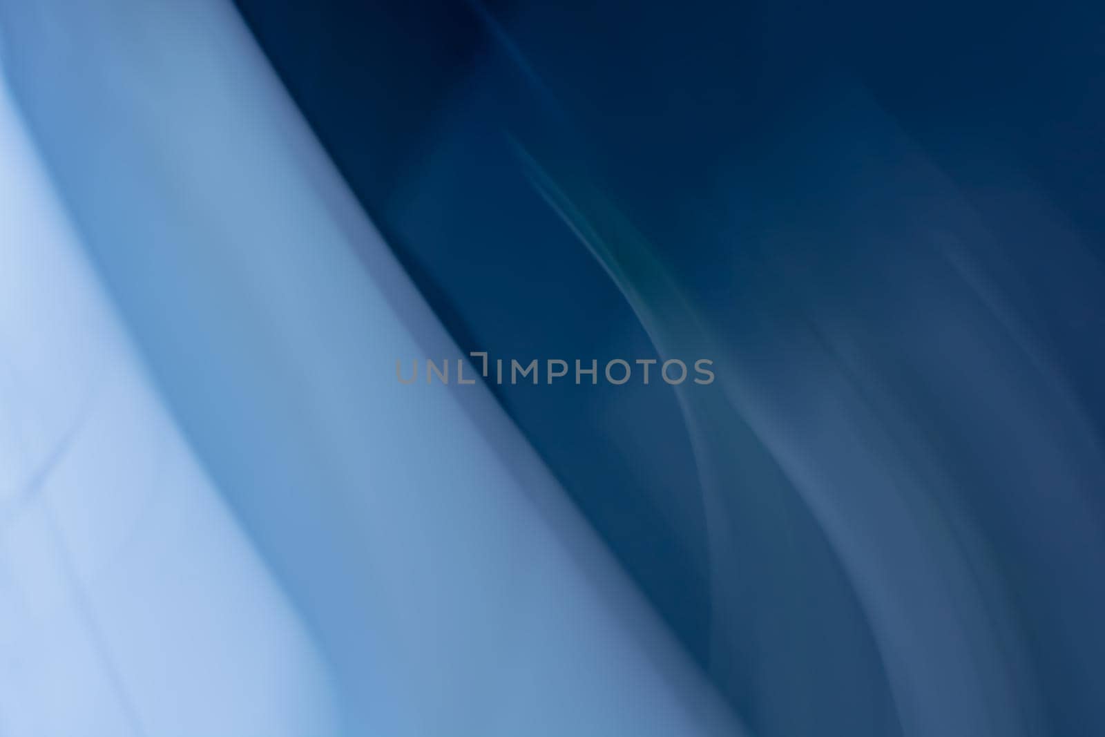 Horizontal blue abstract curtain banner background with diagonal stripes waves and gradient from light to dark tones.