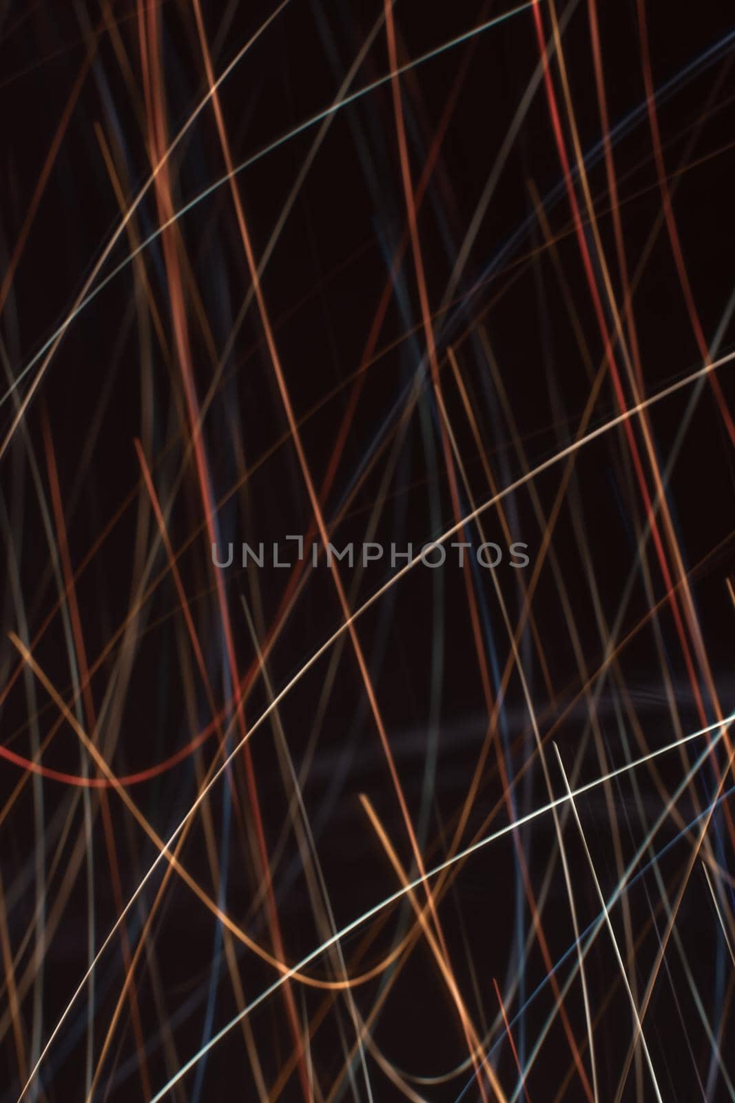 Blurred light from festive garlands. Backdrop. Vertical background with multicolored lines.