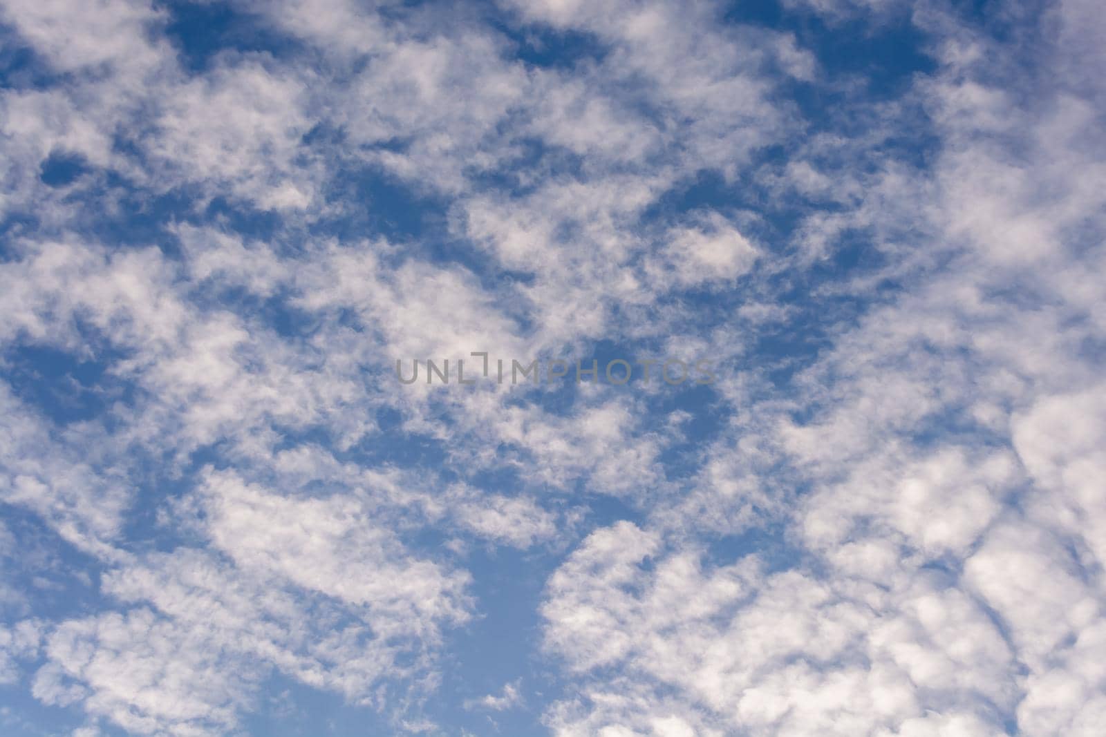 Many white clouds on a clear blue sky at sunrise. by orebrik