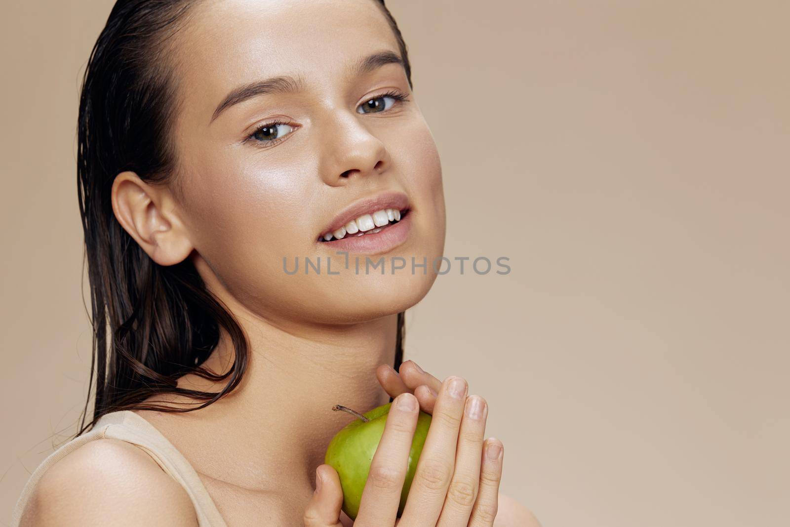 young woman apple in hands posing fruit healthy food fresh beige background. High quality photo