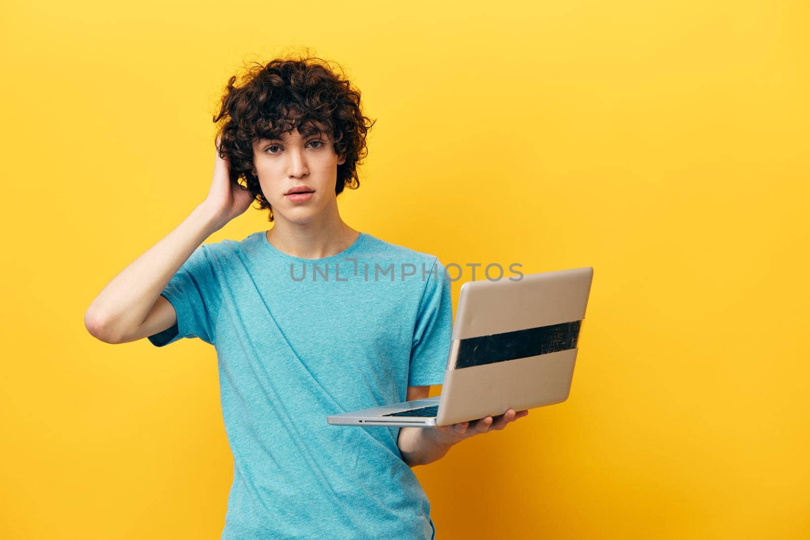guy in blue t-shirts with laptop internet isolated backgrounds. High quality photo
