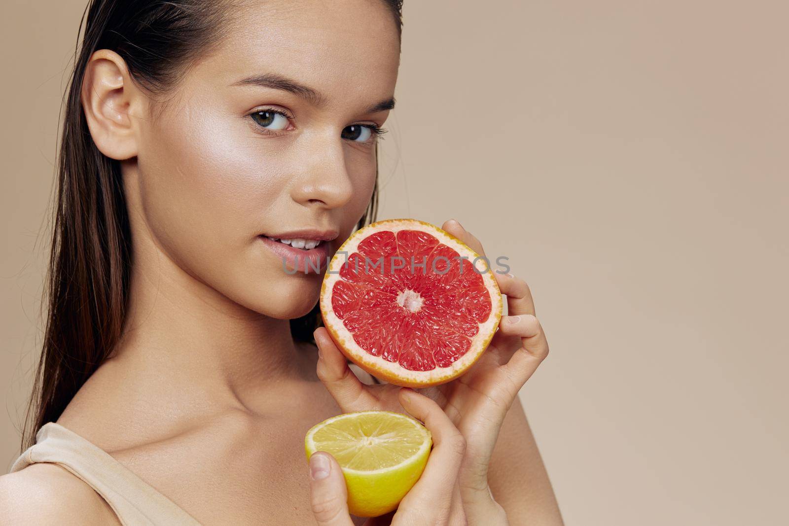 portrait woman lemon and grapefruit in hands posing clean skin close-up Lifestyle. High quality photo