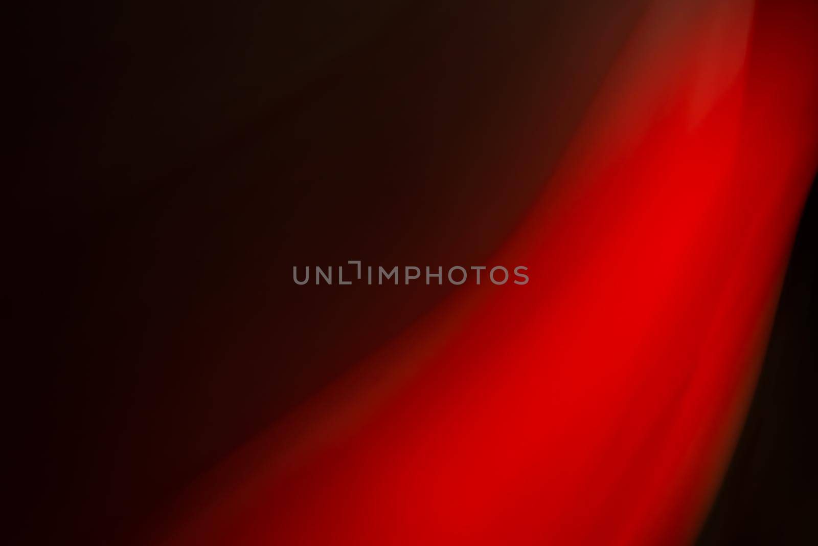 Abstract red light on a black background. Backdrop.