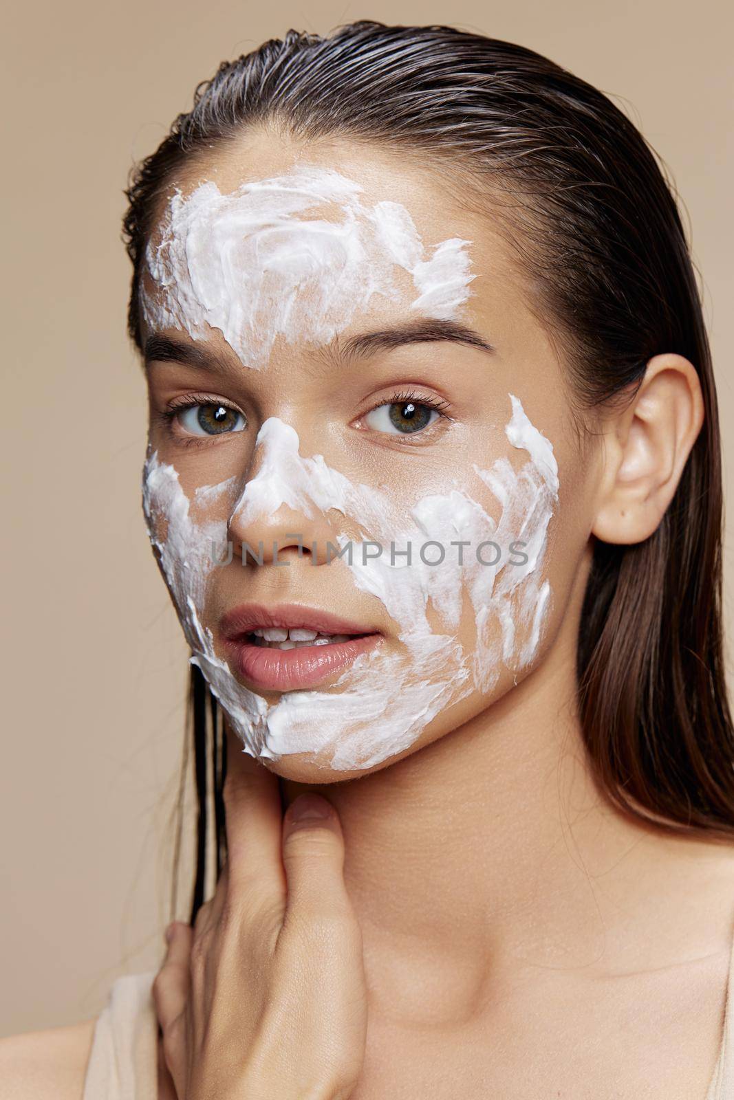 Beautiful Woman skin care by using white mask on the face isolated background. High quality photo