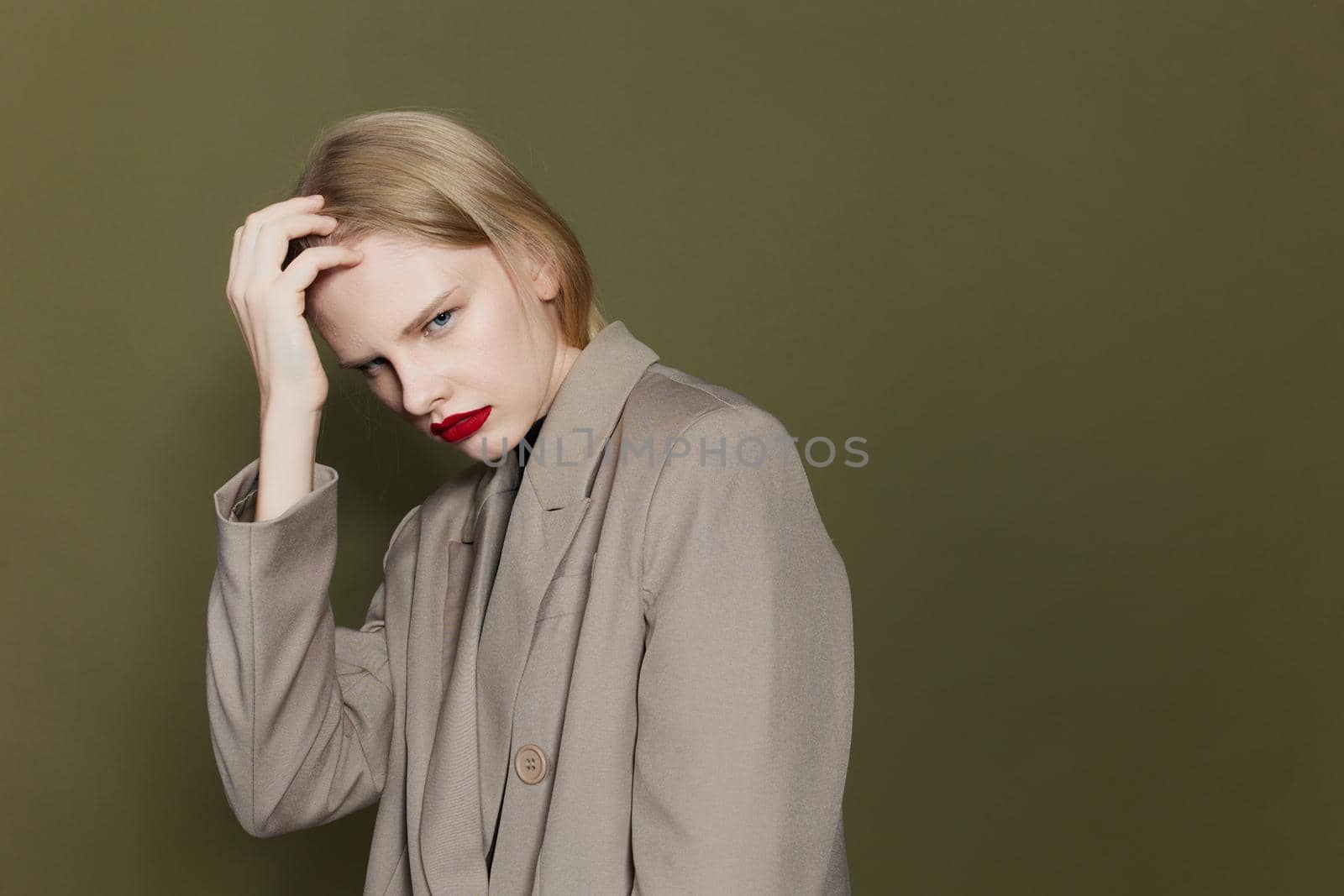 pretty woman with red lips coat bright makeup studio model unaltered. High quality photo