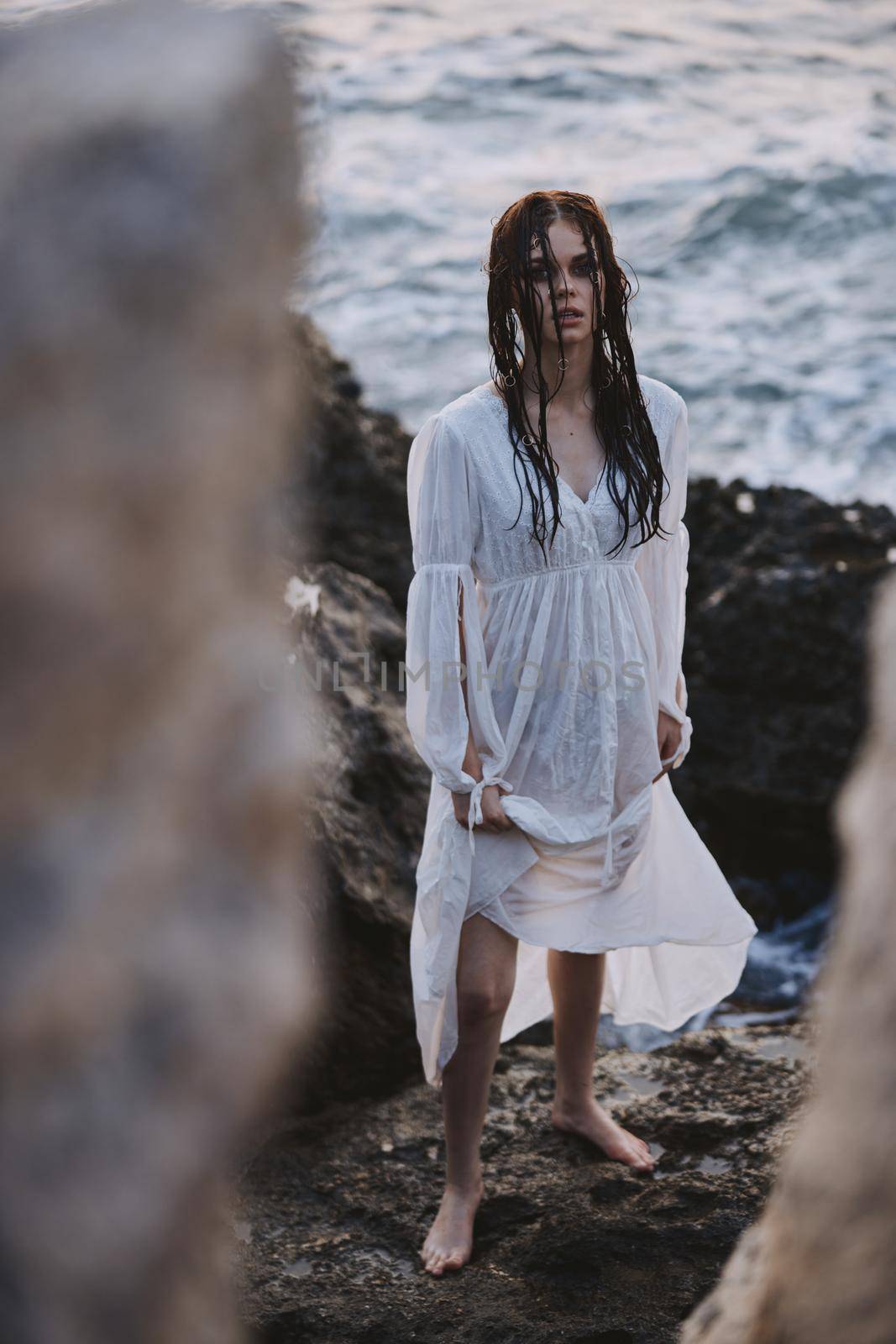 Beautiful woman in white dress at the sea beach Lifestyle. High quality photo