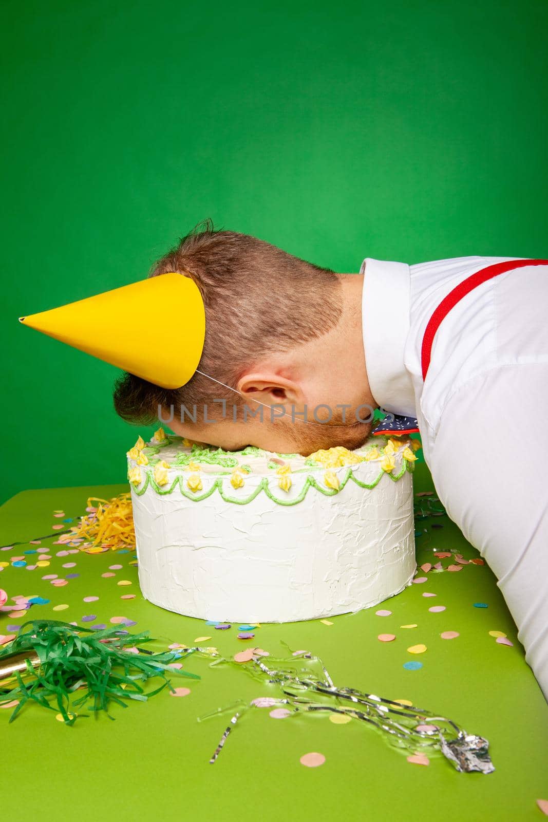 Funny man lying with face in birthday cake by Julenochek