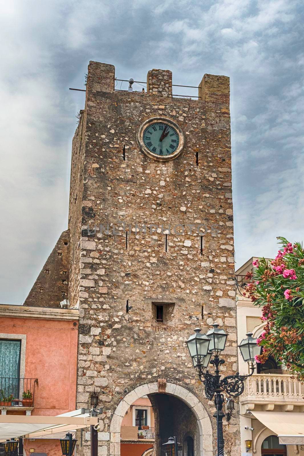 Ancient clocktower, iconic landmark located in the central square of Taormina, Sicily, Italy
