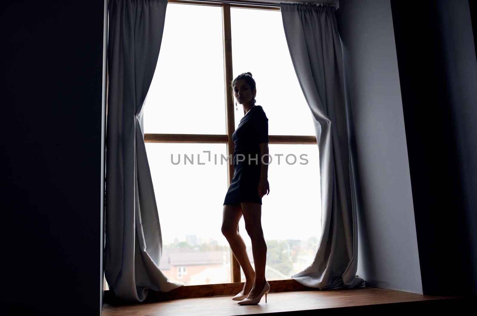 silhouette of woman home interior window. High quality photo