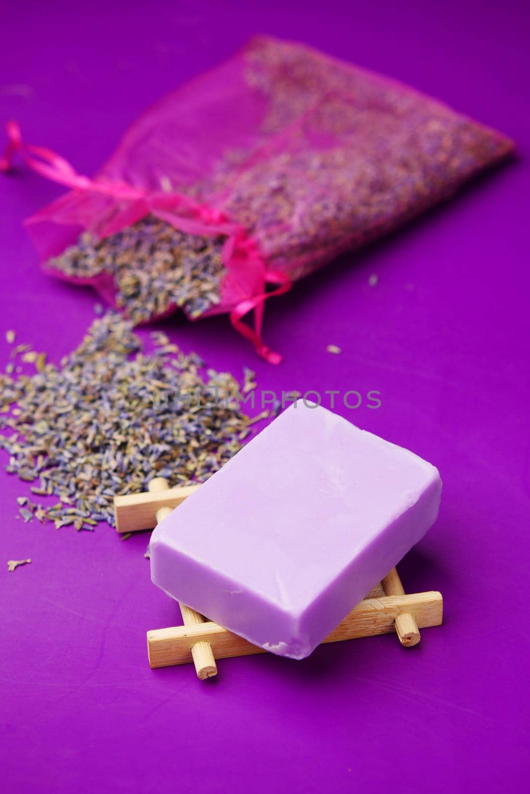 Homemade natural soap bar and lavender flower on purple background by towfiq007