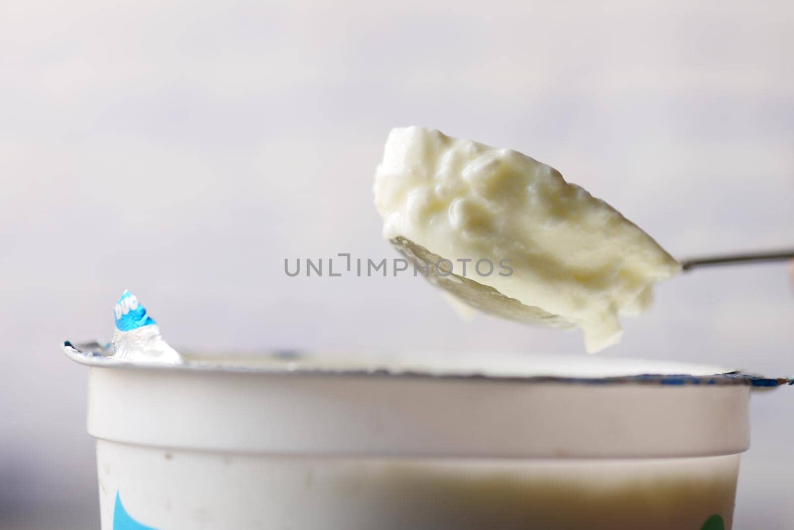 fresh yogurt on a spoon close up .