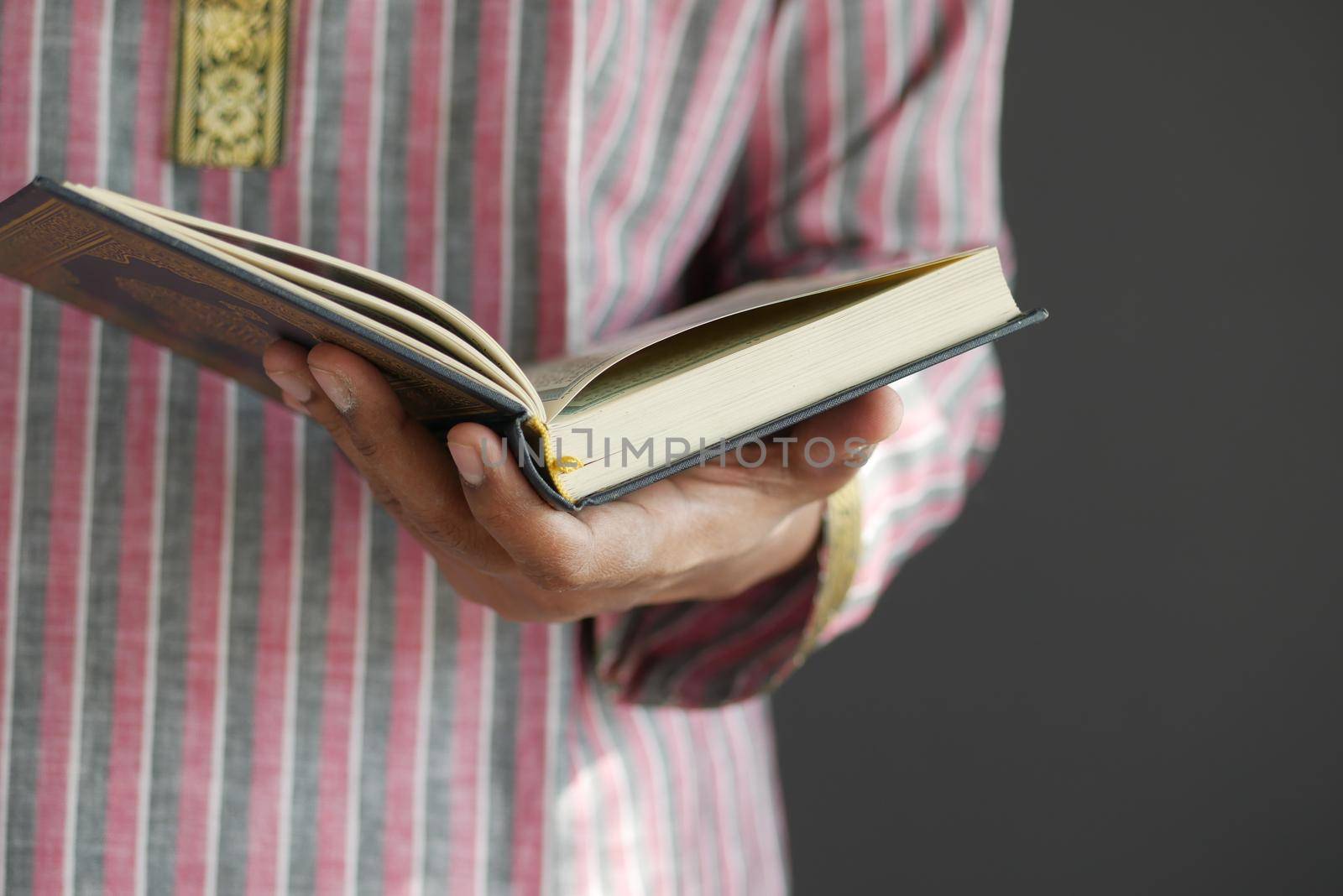 muslim man hand holding Holy book Quran with copy space ,