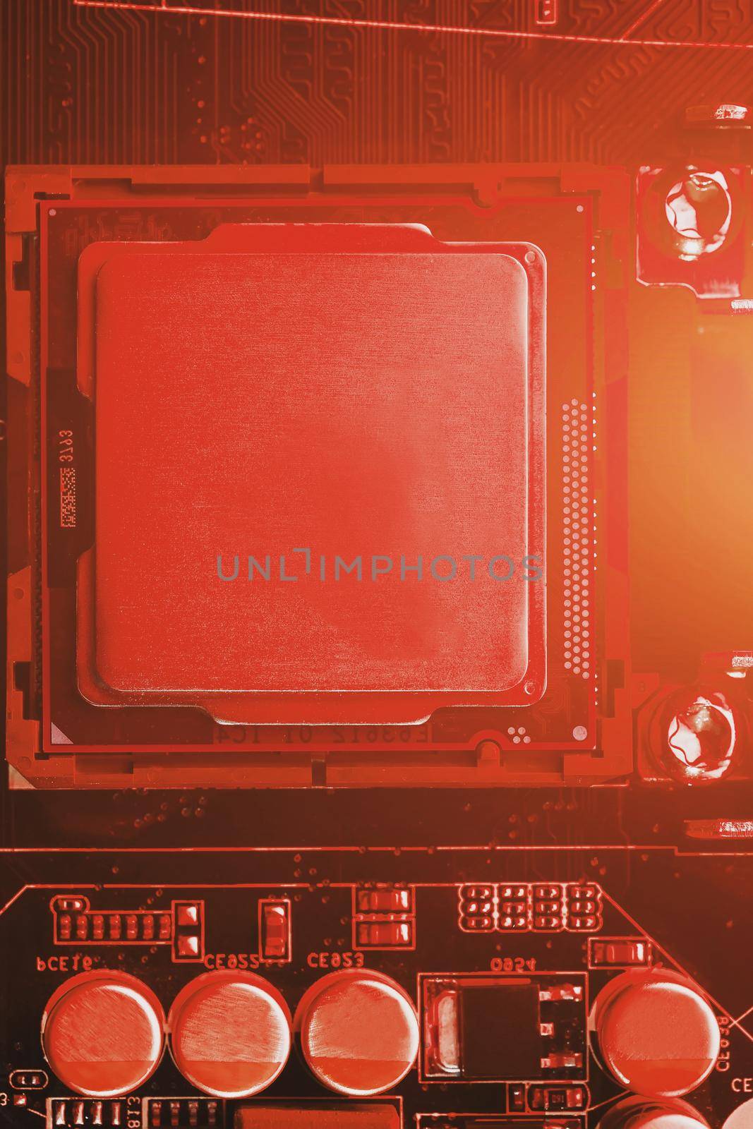 The central processor on the computer motherboard in red colors. PC repair, technician and industry support concept.