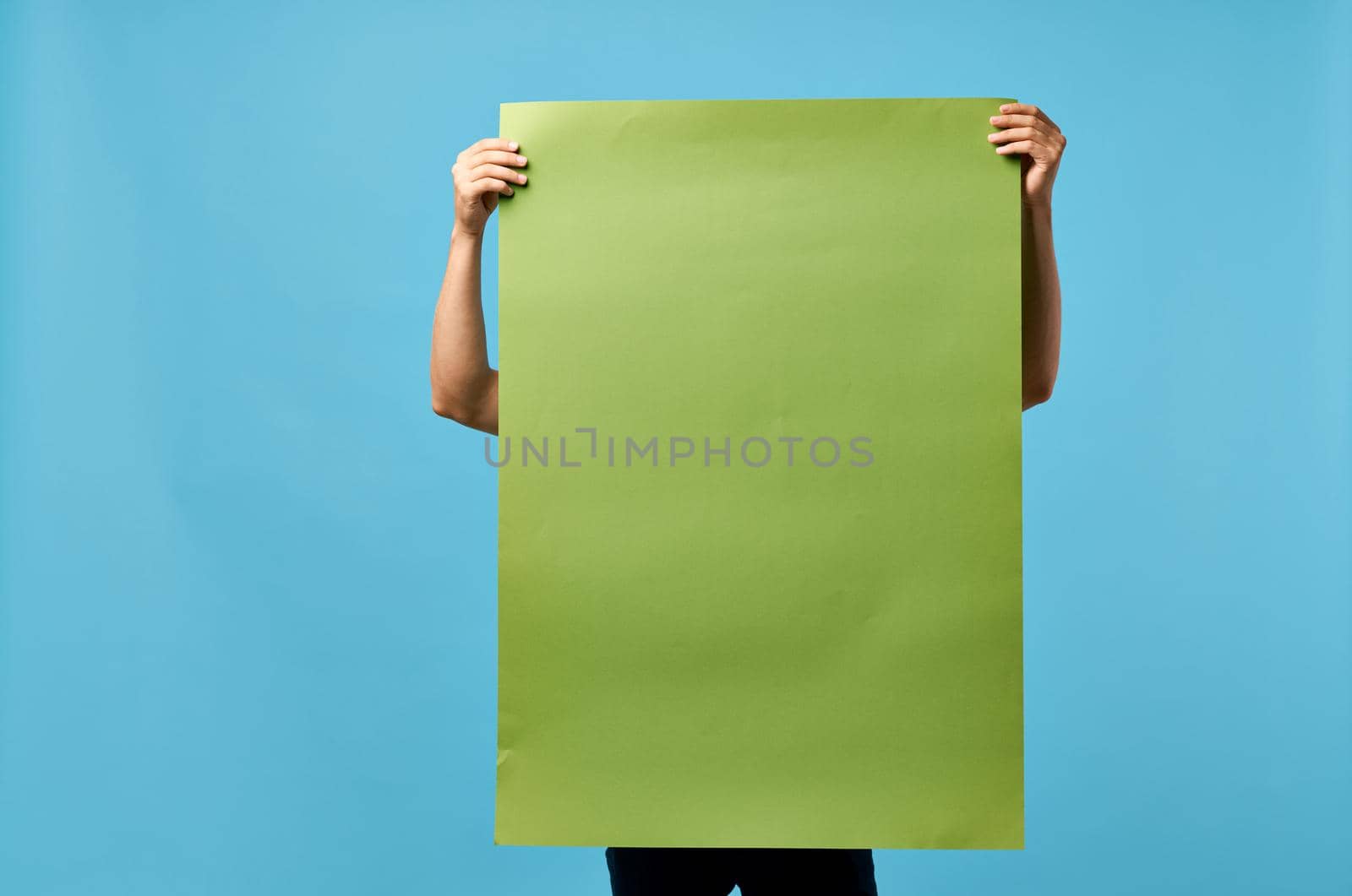 handsome man green banner in hand blank sheet copy-space studio. High quality photo