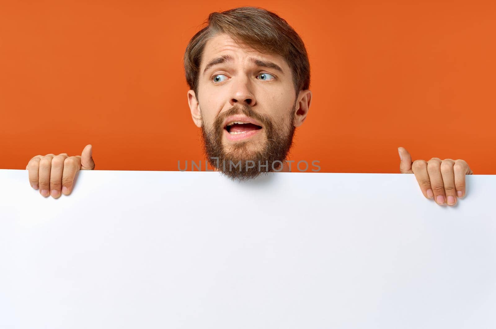 bearded man holding a white banner design isolated background. High quality photo