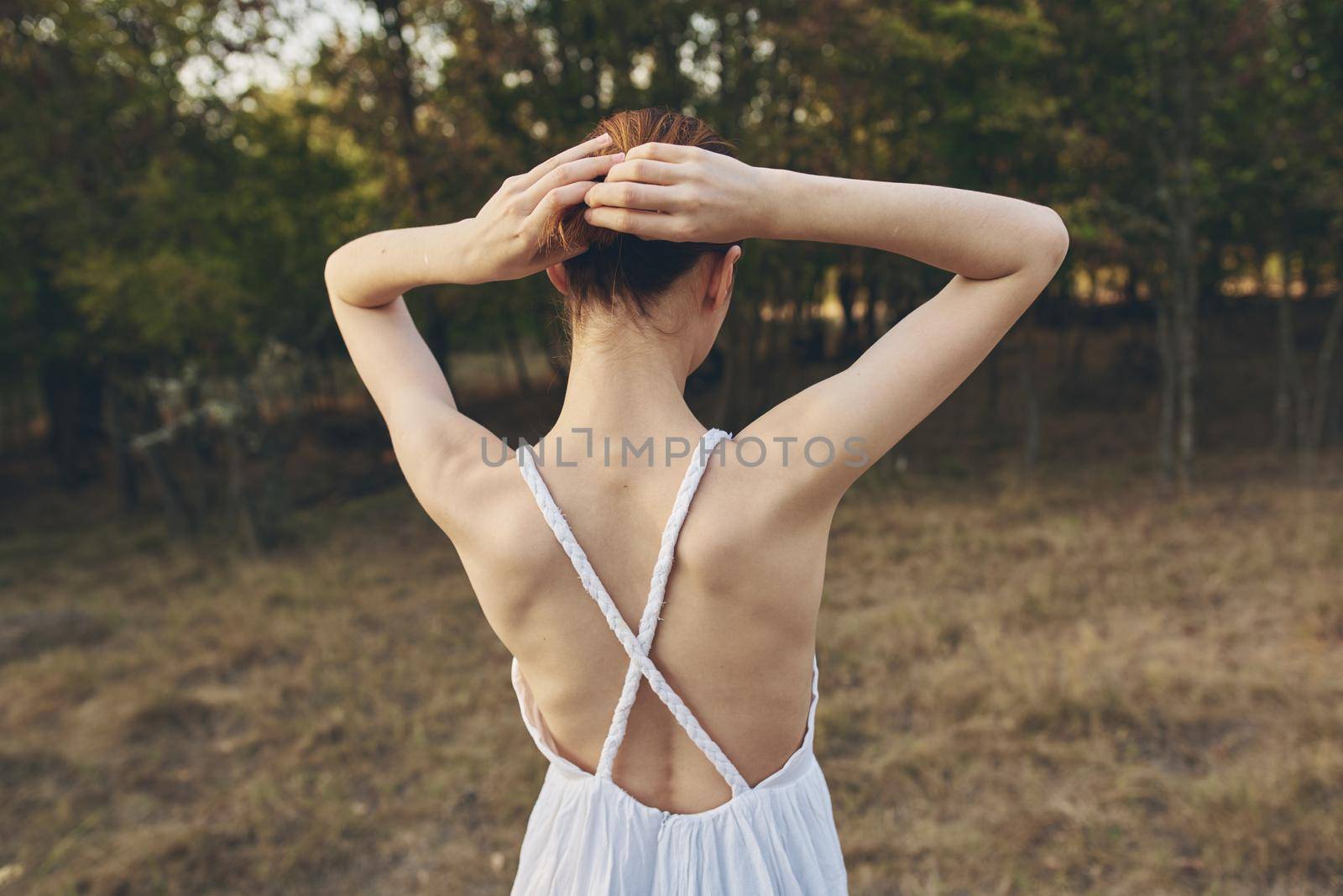 cheerful woman nature freedom in the field walk fresh air. High quality photo