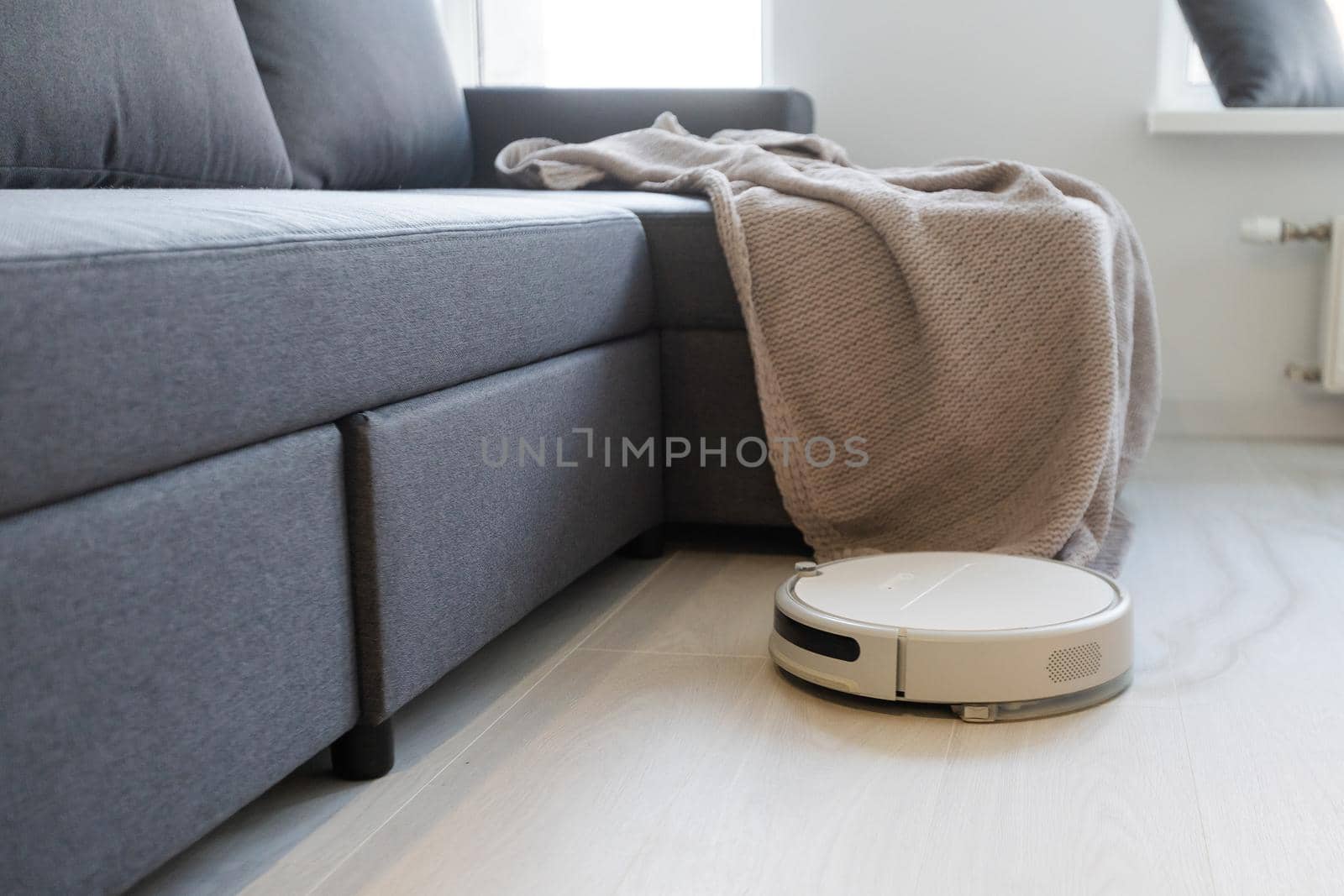 robotic vacuum cleaner on laminate wood floor smart cleaning technology by Andelov13