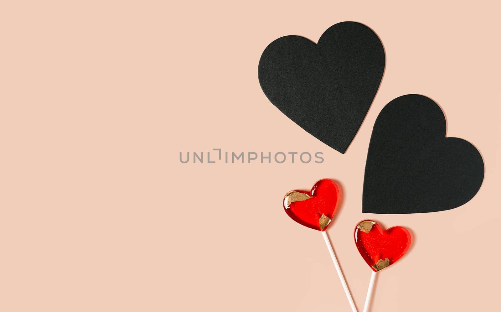 Background chalkboard black hearts, lollipops with free space for text on pink background. Valentines day concept. Mother's Day concept. Mockup Greetings card. Copy space. Flat lay, top view.
