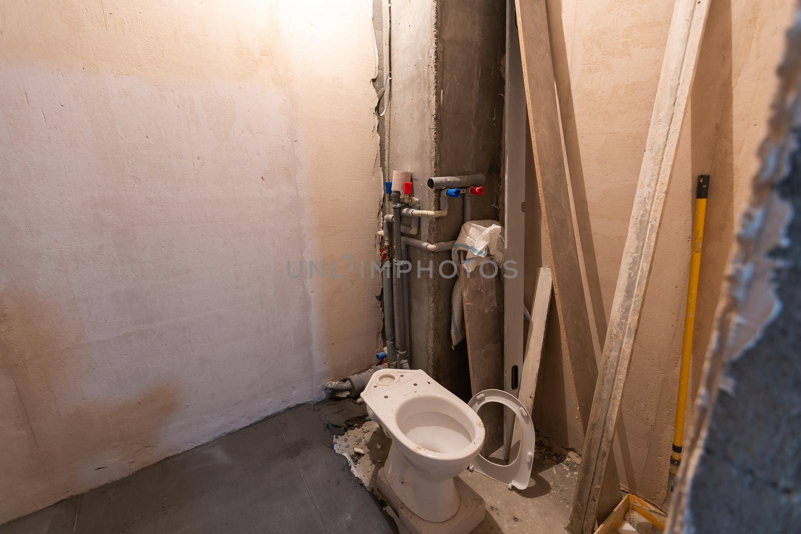 Toilet bowl in the bathroom. Repair. Sanitary ceramics. Plumbing. Water pipes. Plastic faucet. Floor standing toilet