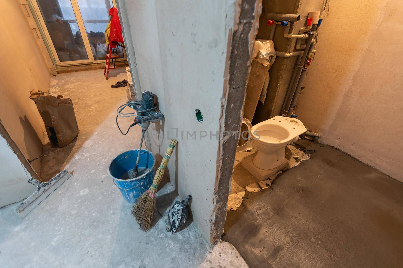 Toilet bowl in the bathroom. Repair. Sanitary ceramics. Plumbing. Water pipes. Plastic faucet. Floor standing toilet