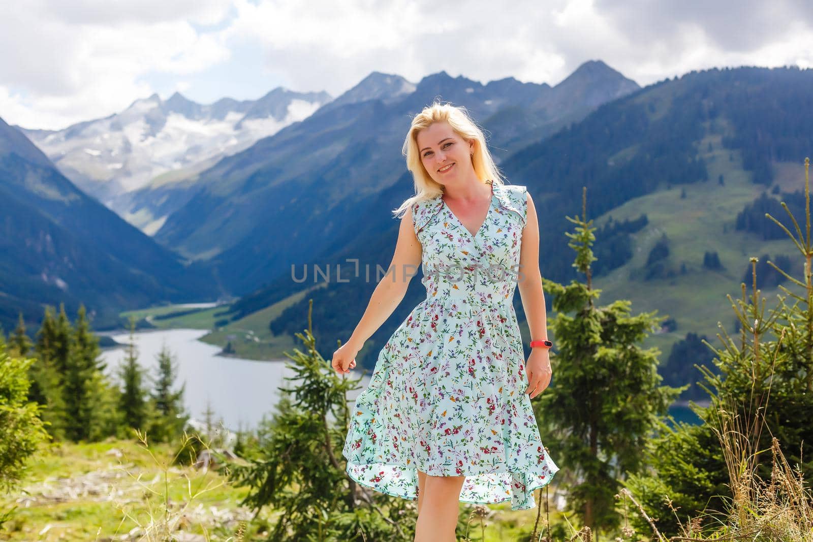 Young beautiful woman traveler , mountains Alps background