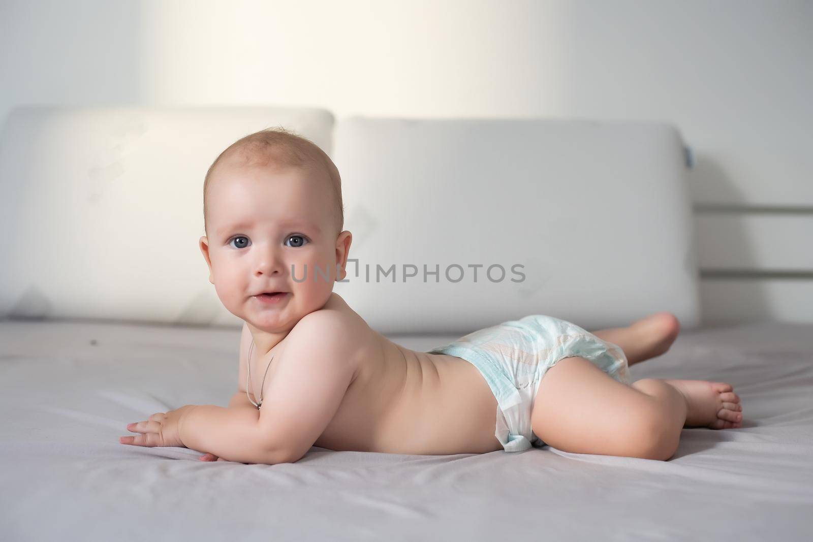 Six month boy sits on the white background by Andelov13