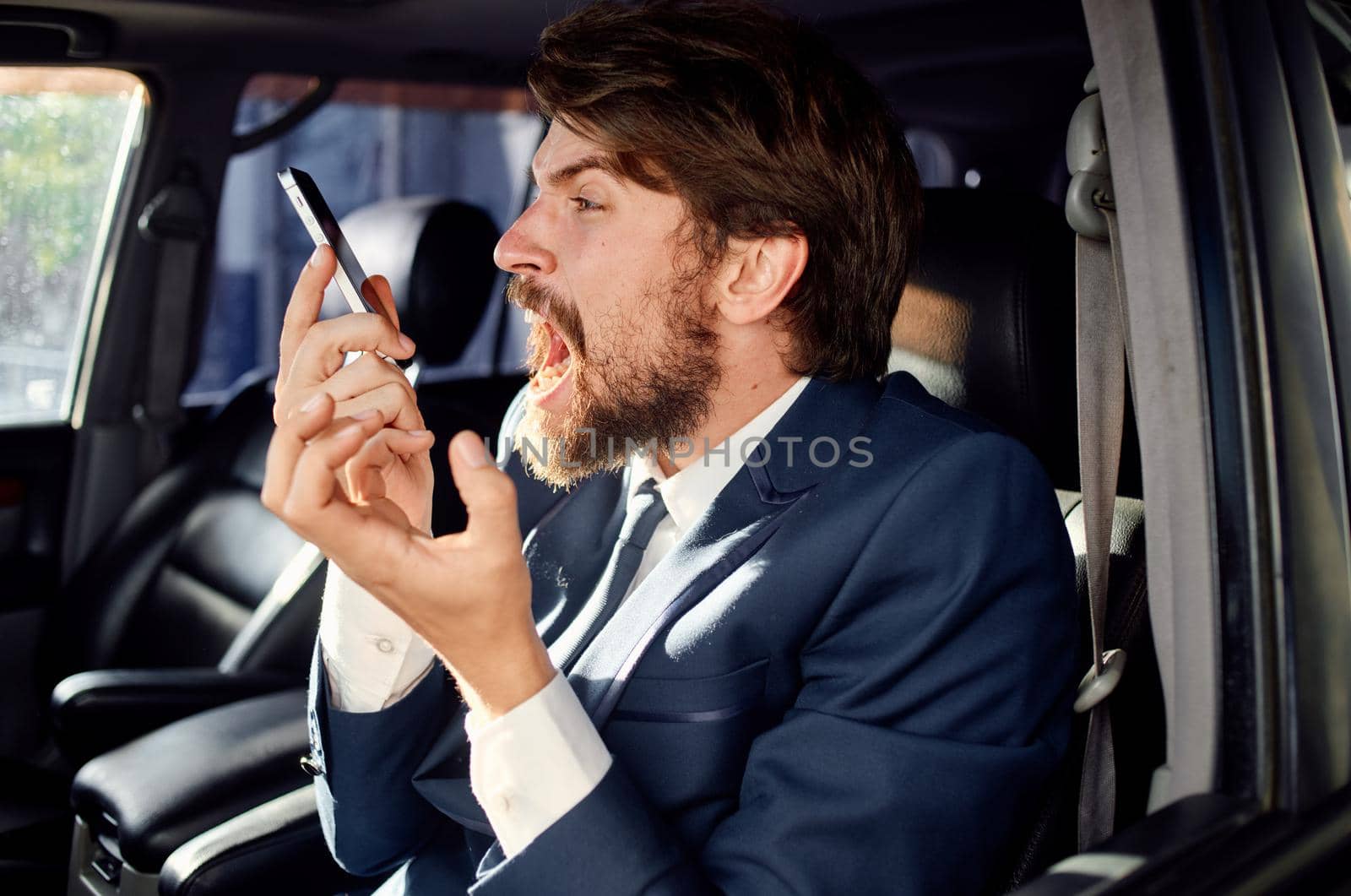 businessmen in a suit in a car a trip to work service. High quality photo