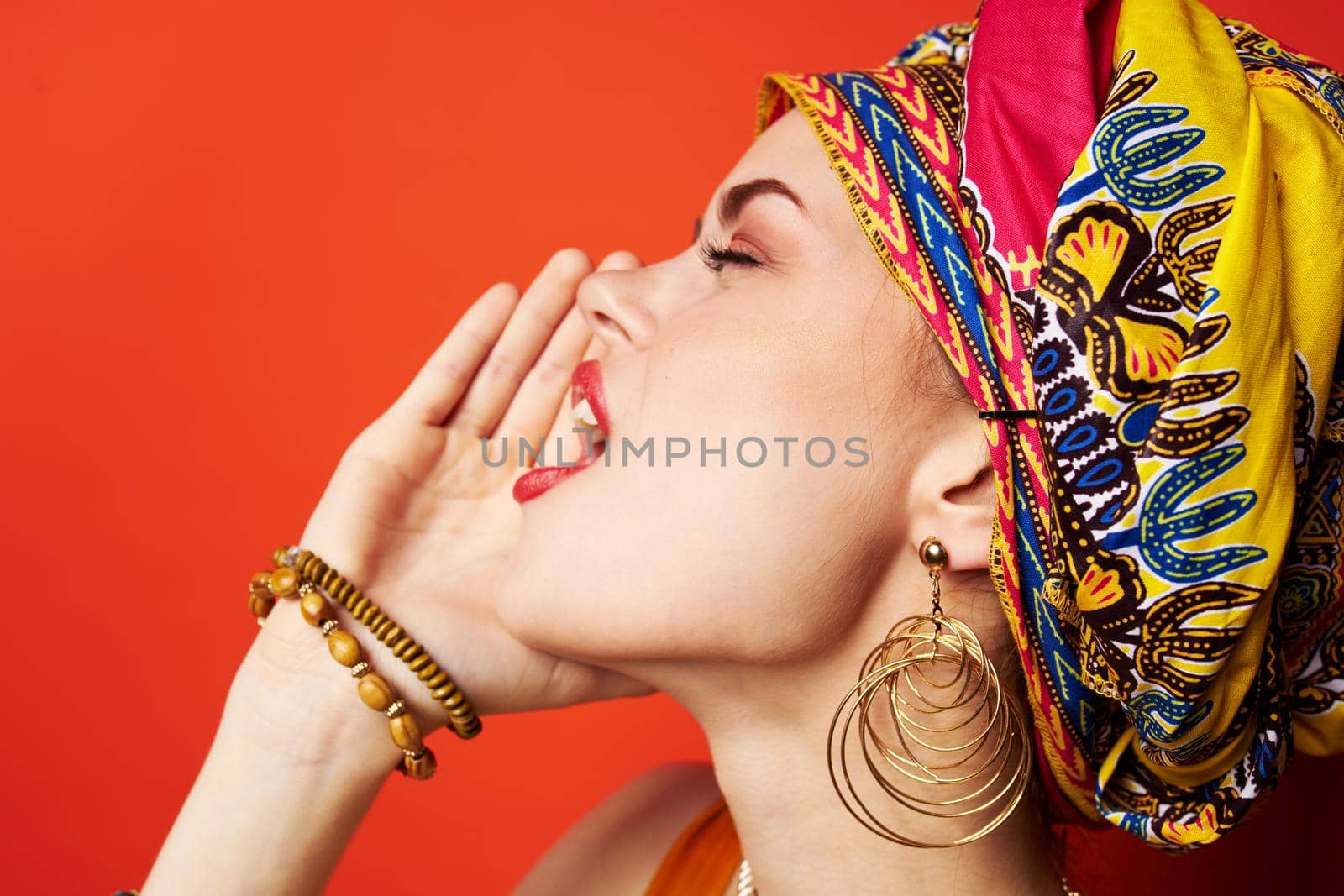 cheerful woman ethnicity multicolored headscarf makeup glamor Studio Model. High quality photo
