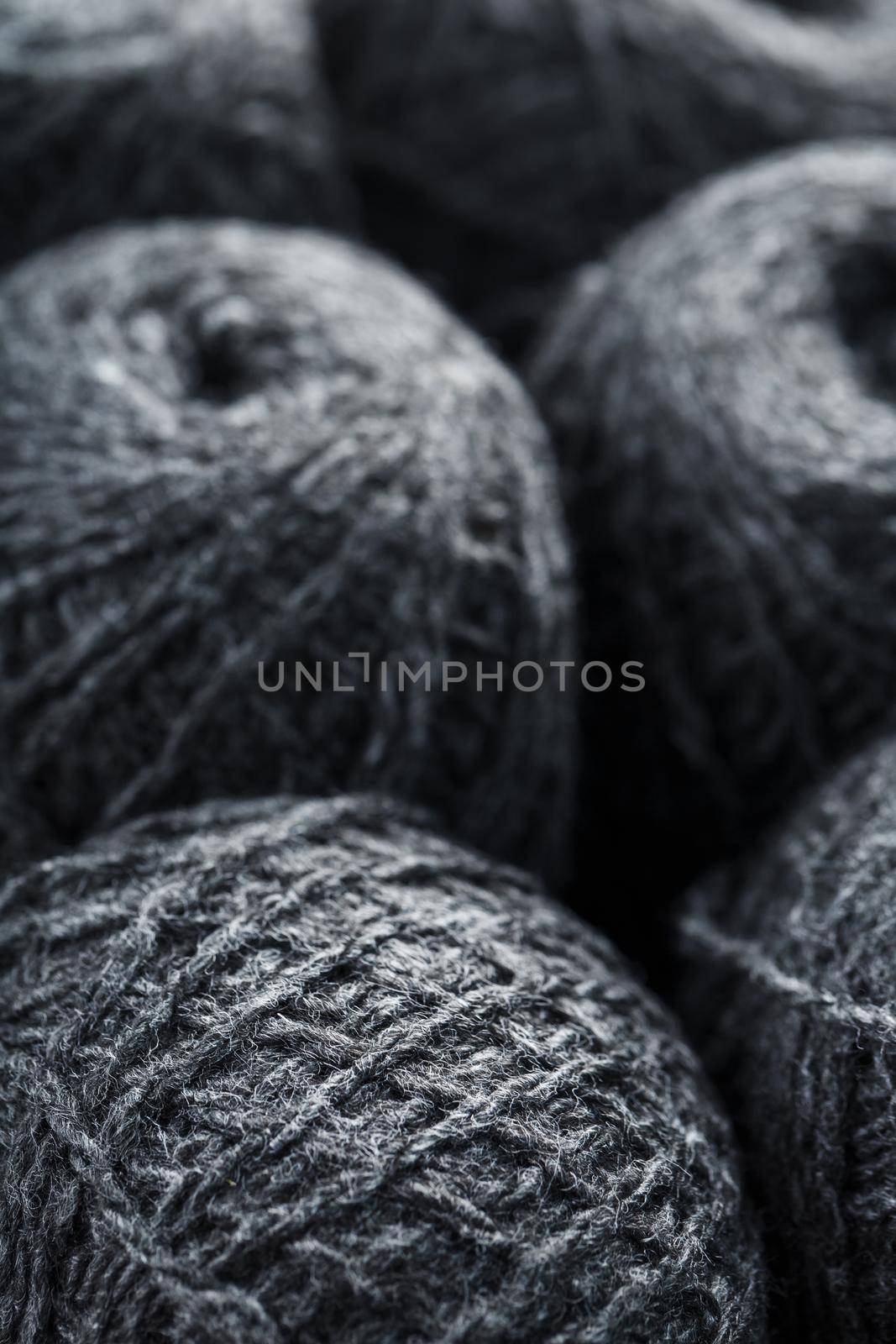 Gray yarn made of natural wool in balls of thread. Close-up