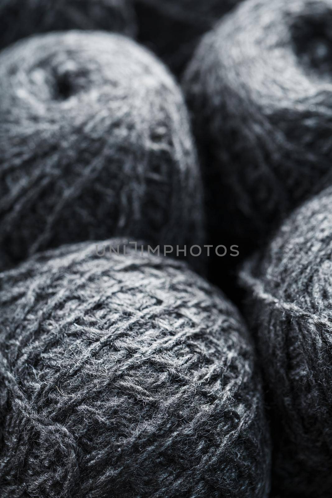 Tangles of gray yarn made of natural wool close-up in full screen.