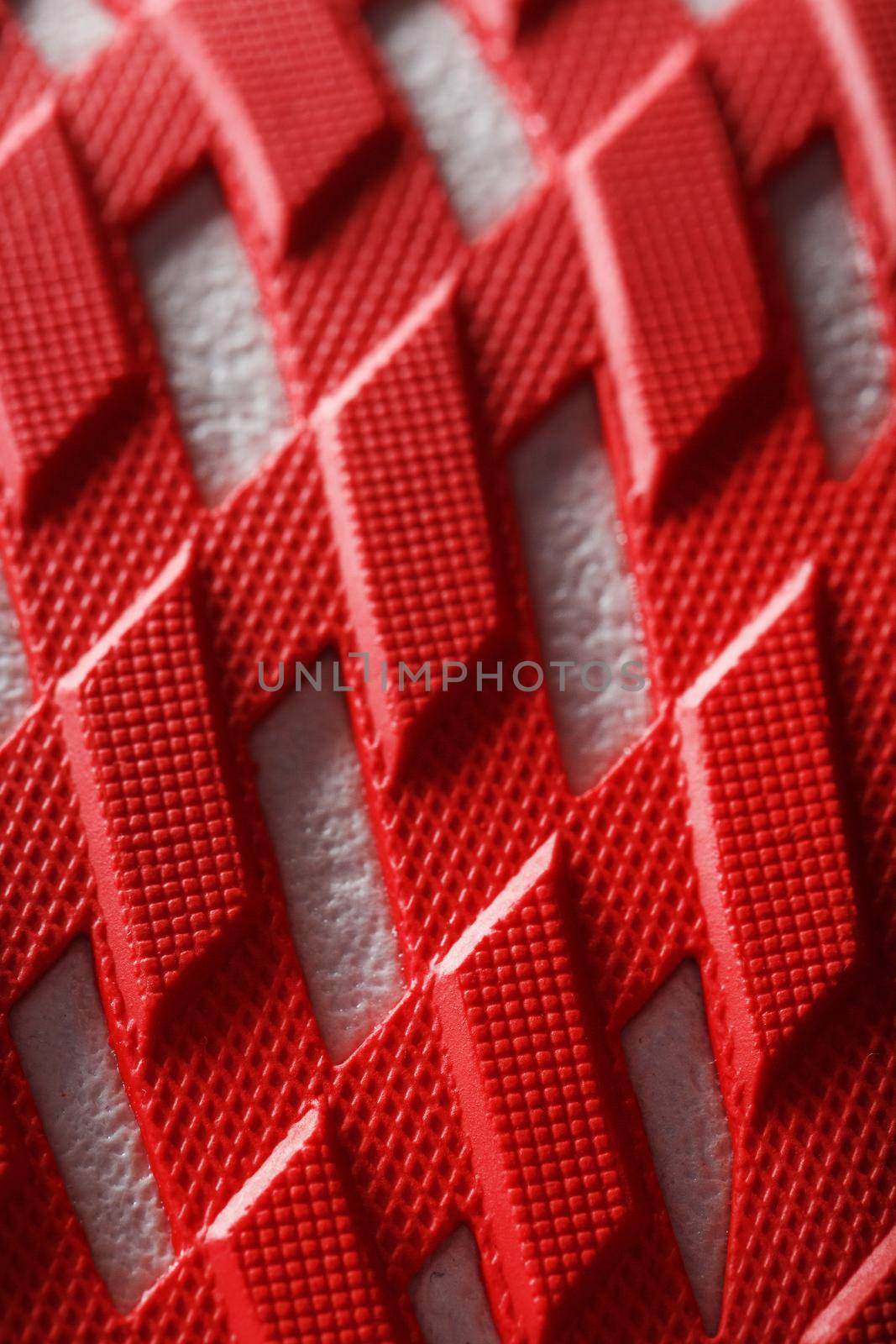 Running shoes with red soles on a black background. Close-up, top view