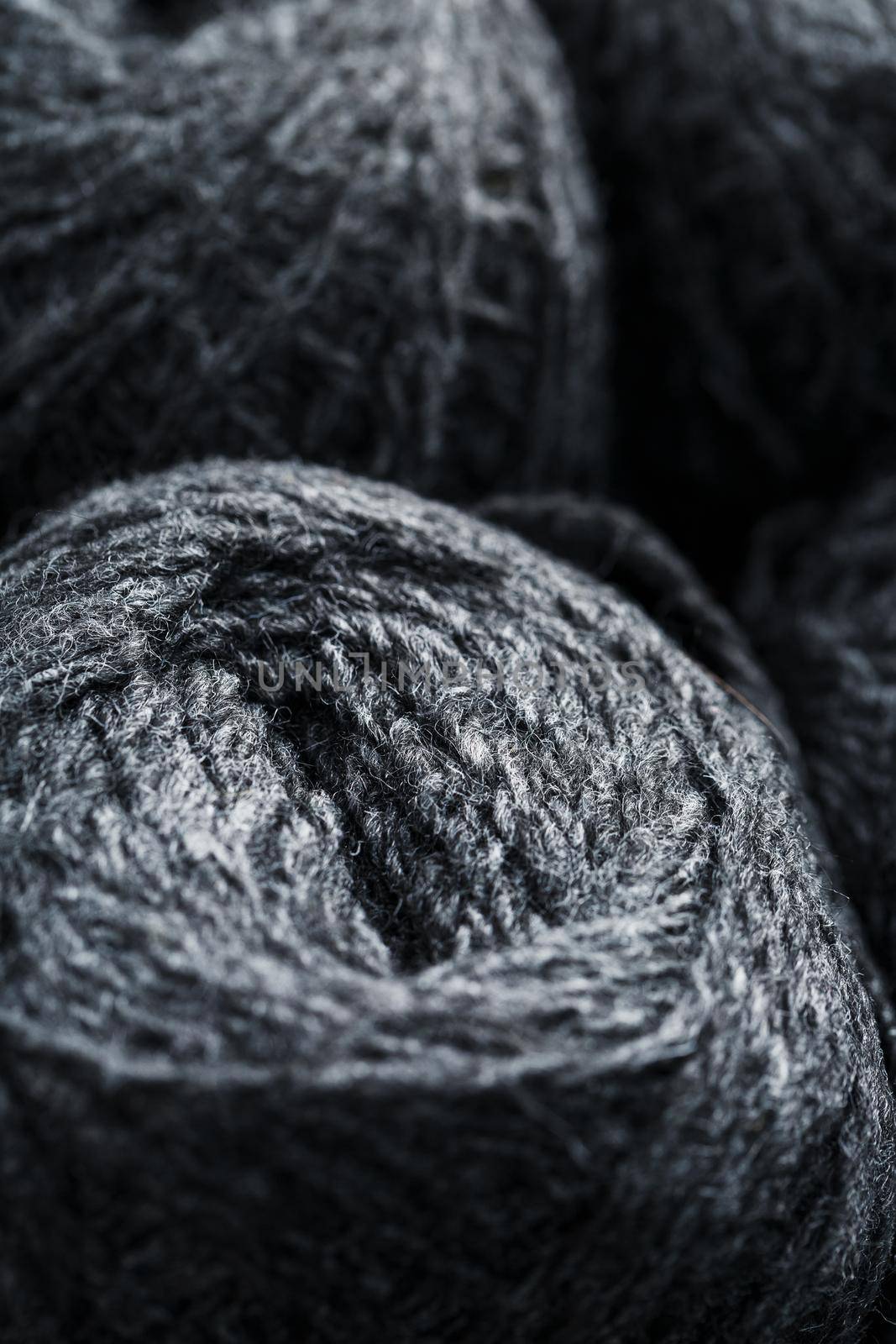 Tangles of gray yarn made of natural wool close-up in full screen.