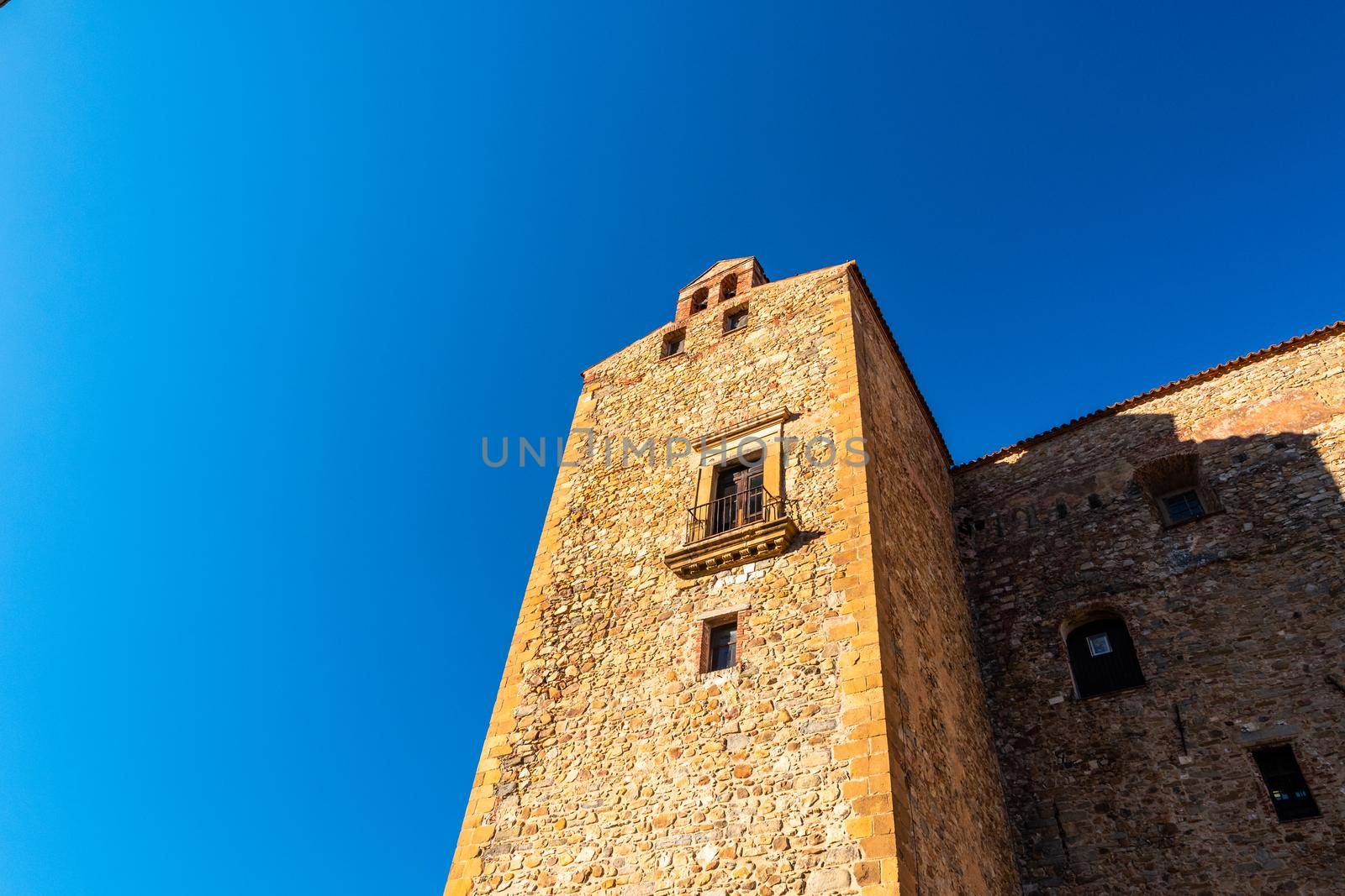 Castelbuono castle illuminated by the afternoon sunlight on a summer day with a blue sky background, Sicily, Italy