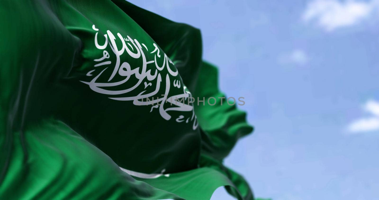 Detailed close up of the national flag of Saudi Arabia waving in the wind on a clear day by rarrarorro