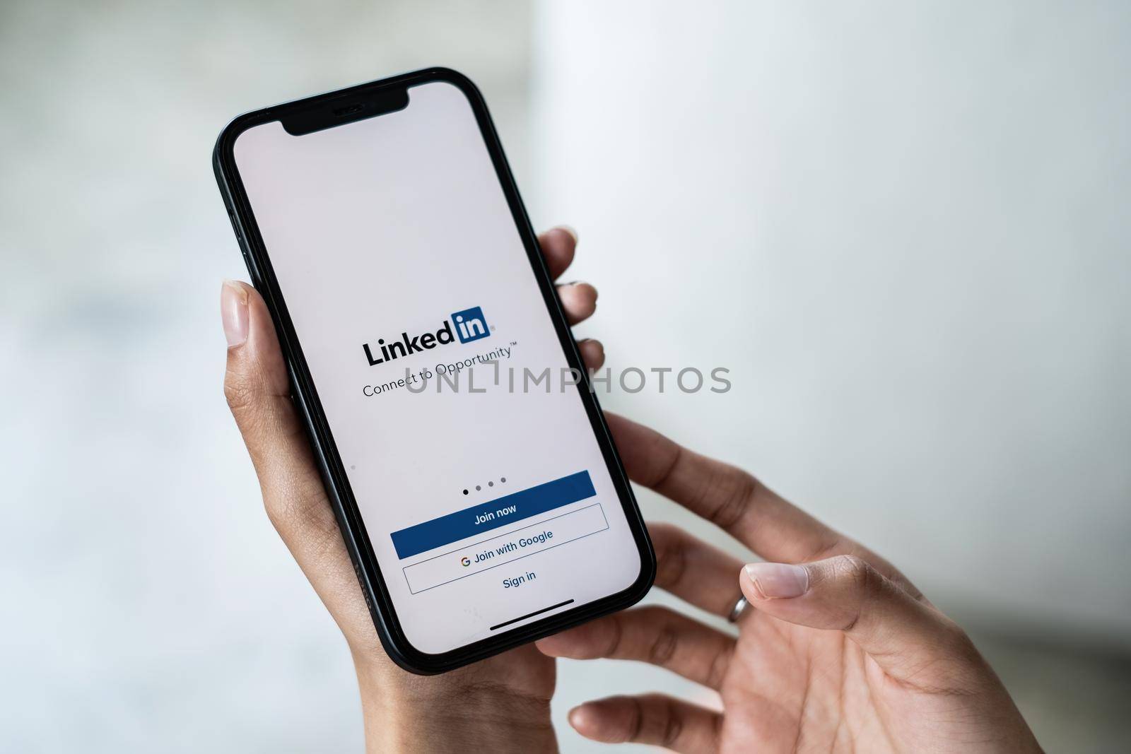 CHIANG MAI, THAILAND - JAN 15, 2022: Woman holding Phone with LinkedIn application on the screen. LinkedIn is a business-oriented social networking. by itchaznong