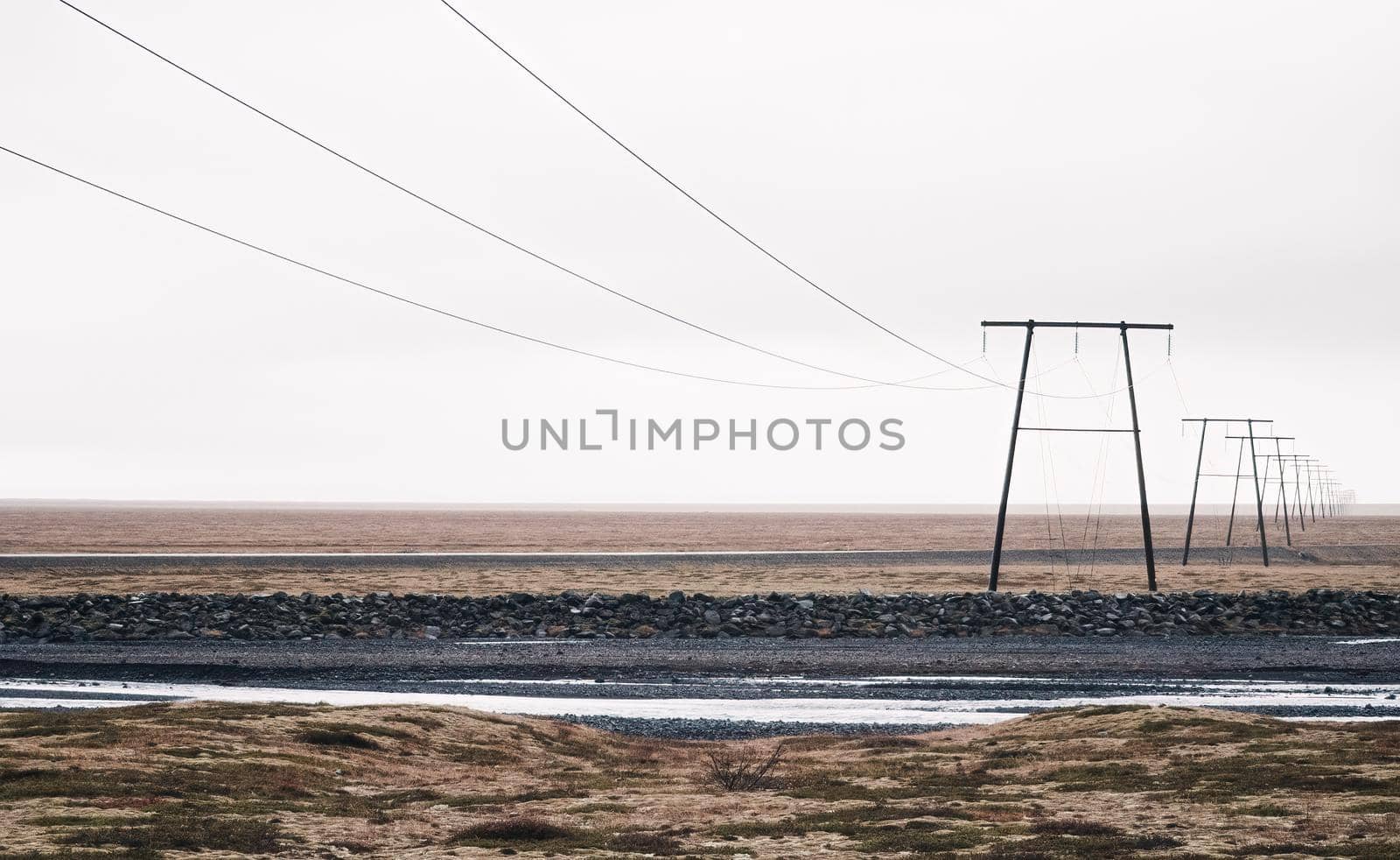 Power lines under white sky lost in the horizon by FerradalFCG