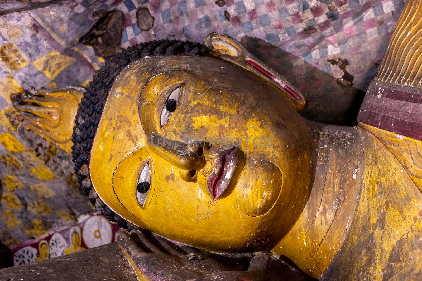 Sri Lanka. Dambulla Cave Temple. The head of the lying Buddha statue in close-up. High quality photo