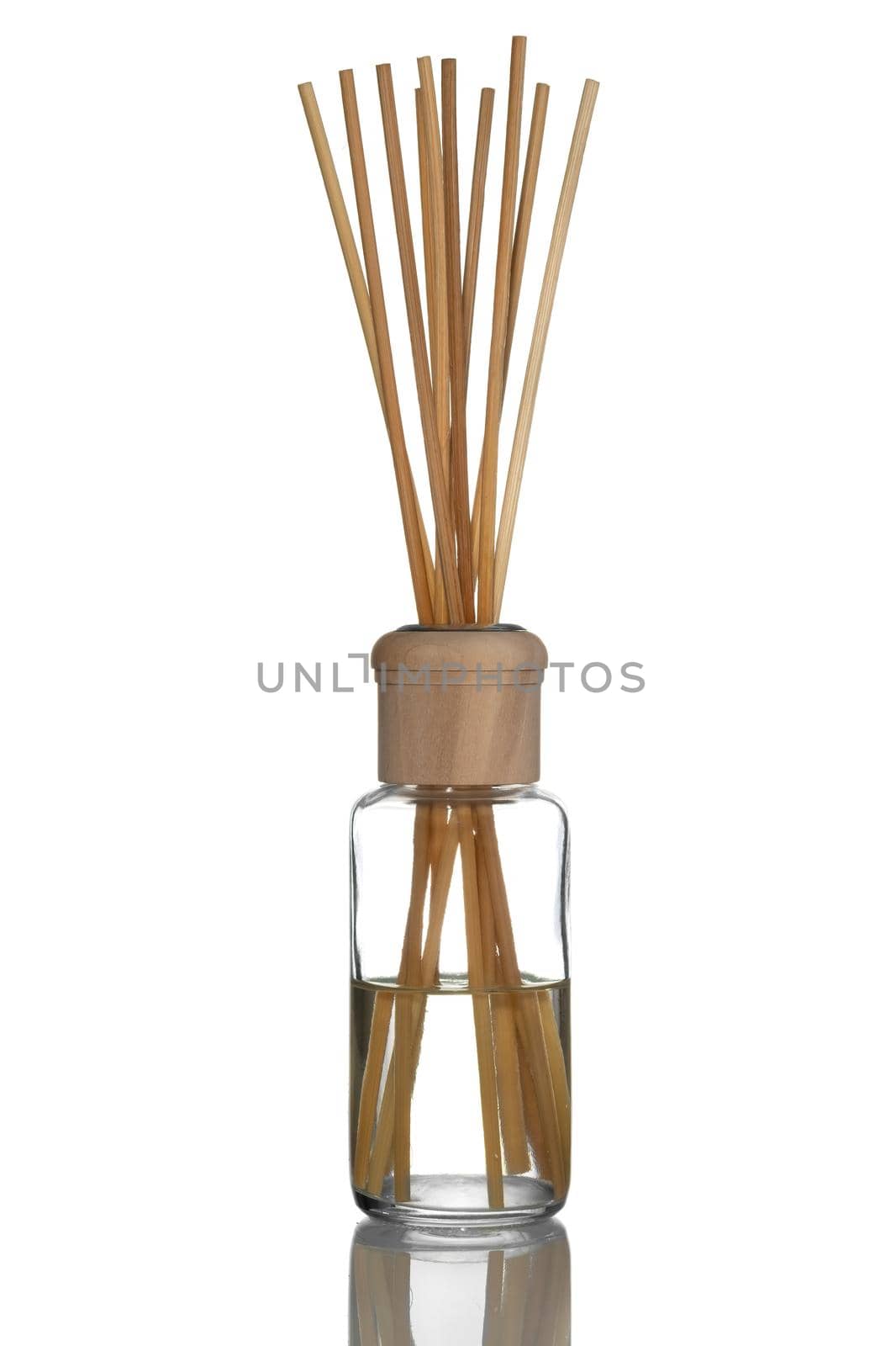 Home fragrance diffuser with wooden sticks on white background.