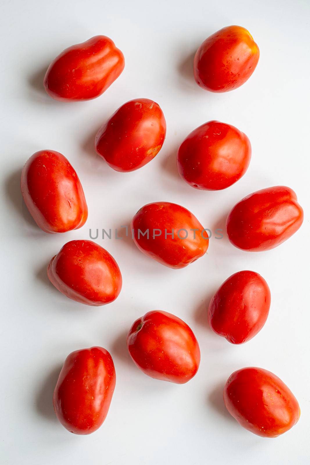 A few tomatoes closeup on white background