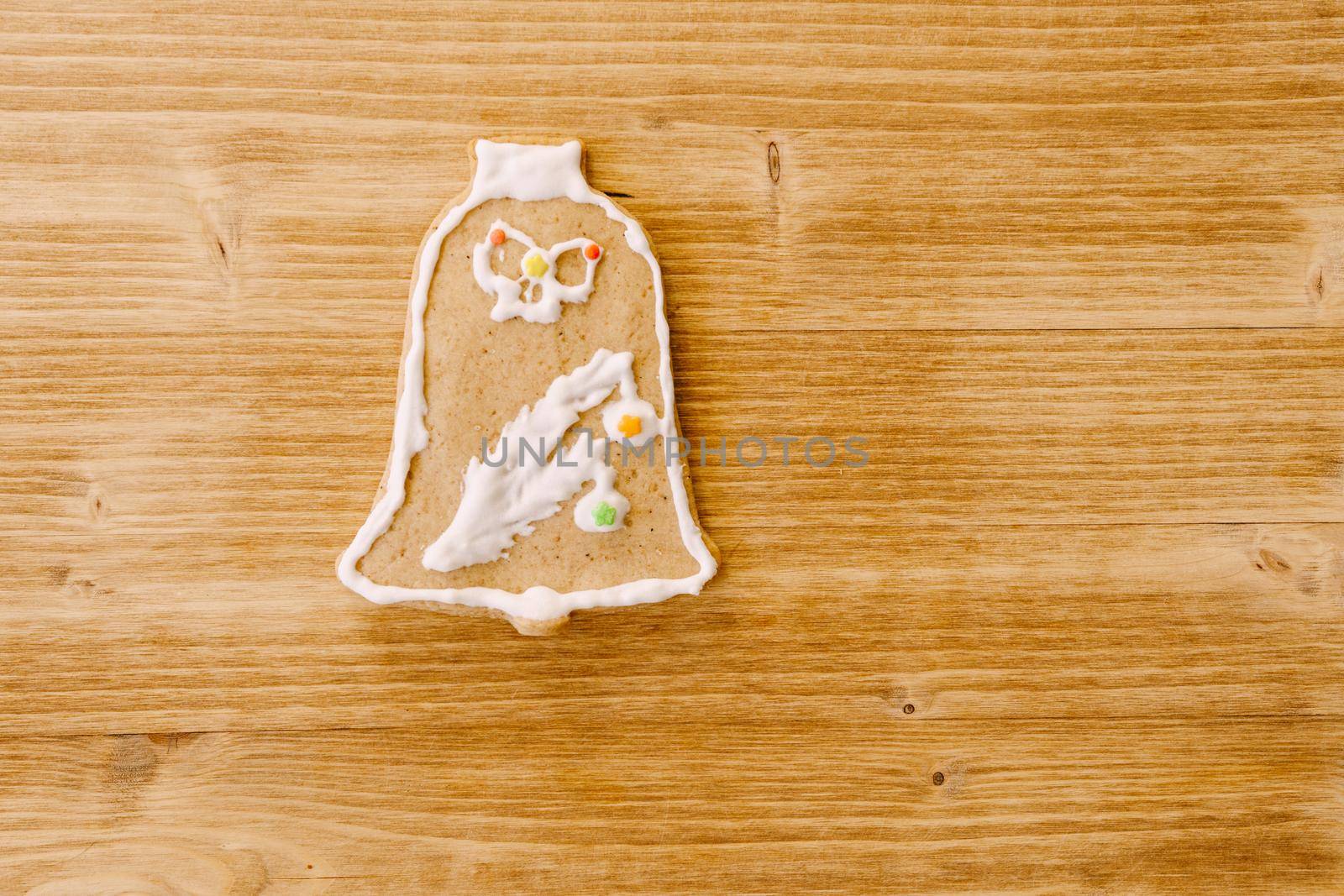 Colorful Christmas gingerbread in the shape of bell decorated with color icing. High quality photo