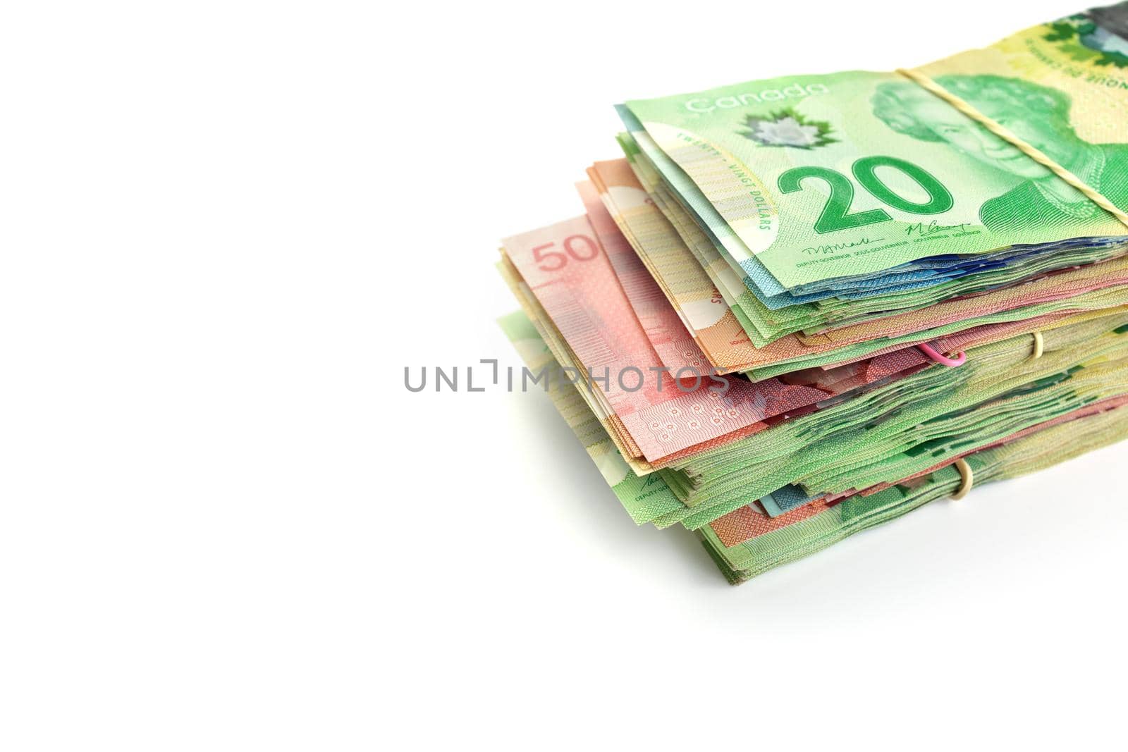 High Angle View of Large Stack of Canadian Banknotes on a White Background by markvandam