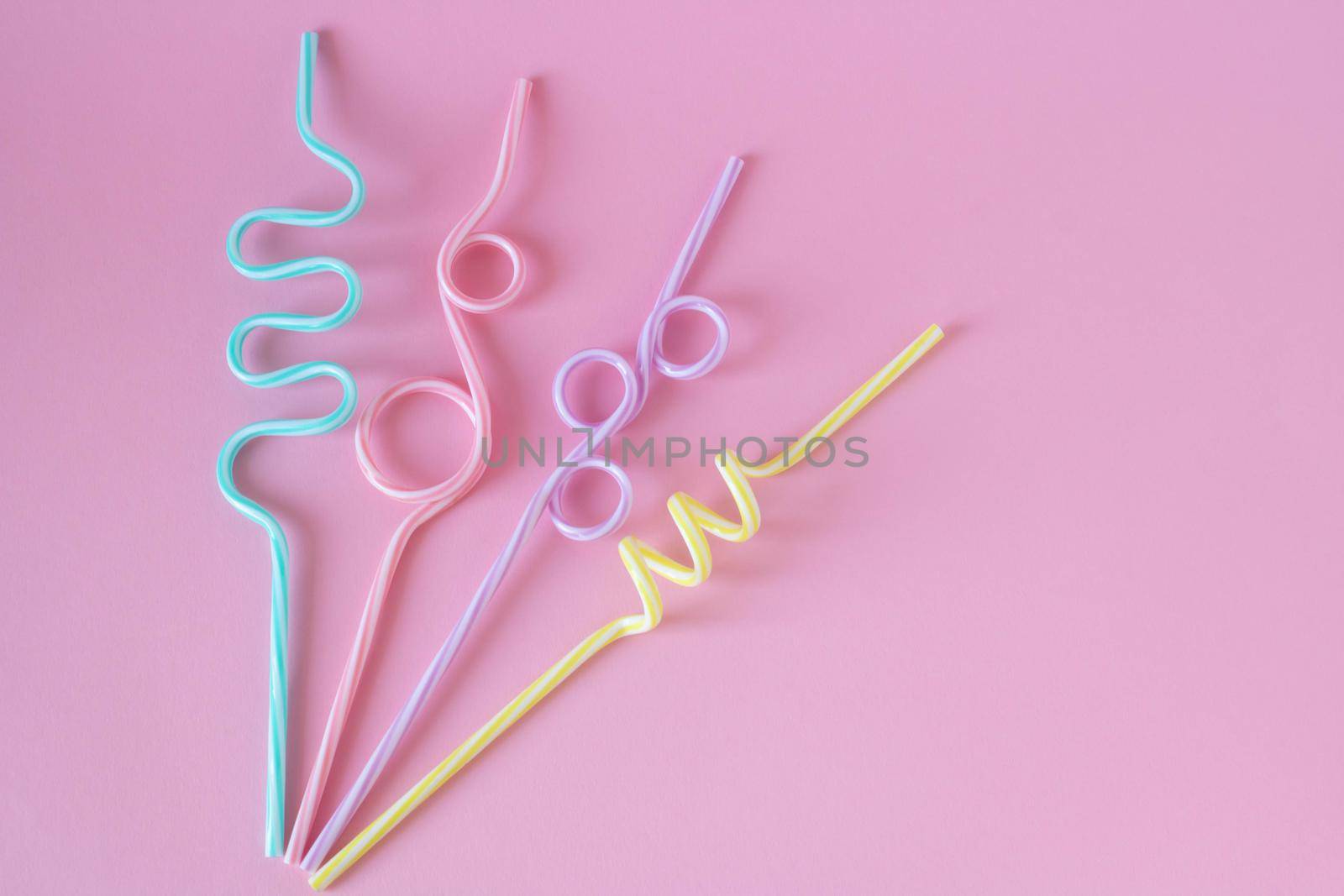 Cocktail straws Day. Drinking straws on a pink background. Summer cocktail party, a fun and happy holiday concept. by lapushka62