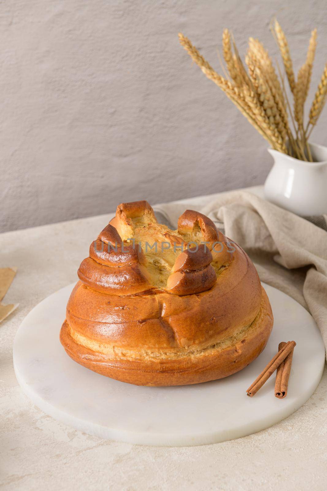 Fogaça on kitchen countertop with eggs and cinammon sticks. Traditional cake from Santa Maria da Feira, Portugal.