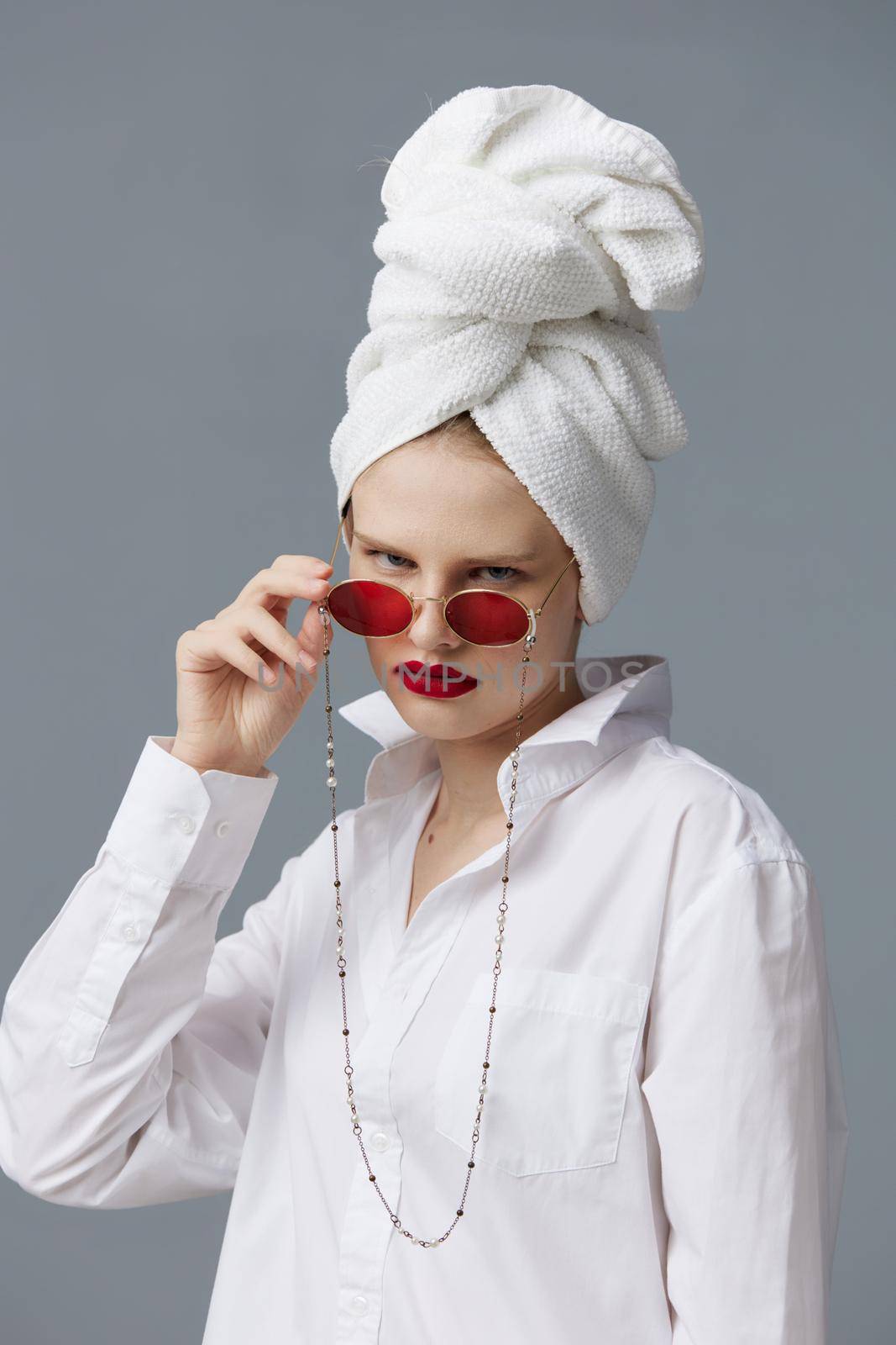 pretty woman red glasses towel on head makeup studio model unaltered. High quality photo