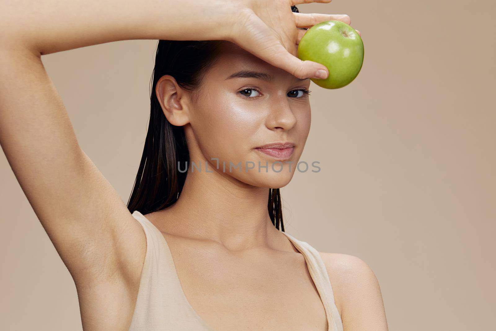 beautiful woman with a green apple smile isolated background. High quality photo