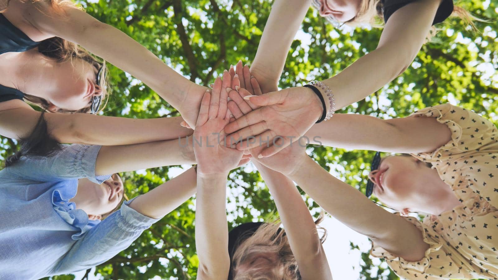 Group of female hands together in the park