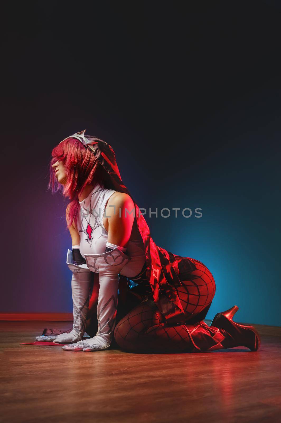 Cosplay portrait of attractive sexy caucasian young cosplay woman in manga anime warrior costume sitting sexy on the floor. Rosary portrait costumed character.