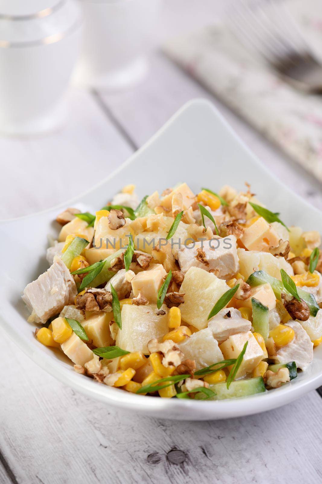 Chicken salad with pineapple, corn and cucumber dressed with Greek yogurt, crushed nuts and cheese.